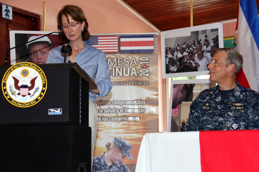Anne S. Andrew, U.S. ambassador to Costa Rica, delivers her speech about the Continuing Promise 2010 mission, Aug. 21, 2010, during the opening ceremony of CP10. Navy Capt. Thomas M. Negus listens to the ambassador as she addresses the citizens. Marines, sailors and USS Iwo Jima personnel will conduct medical, dental, veterinary and engineering services to the Limon community as part of the CP10 mission. CP10 is currently deployed to the Caribbean, Central and South America to provide humanitarian civic assistance to eight nations.