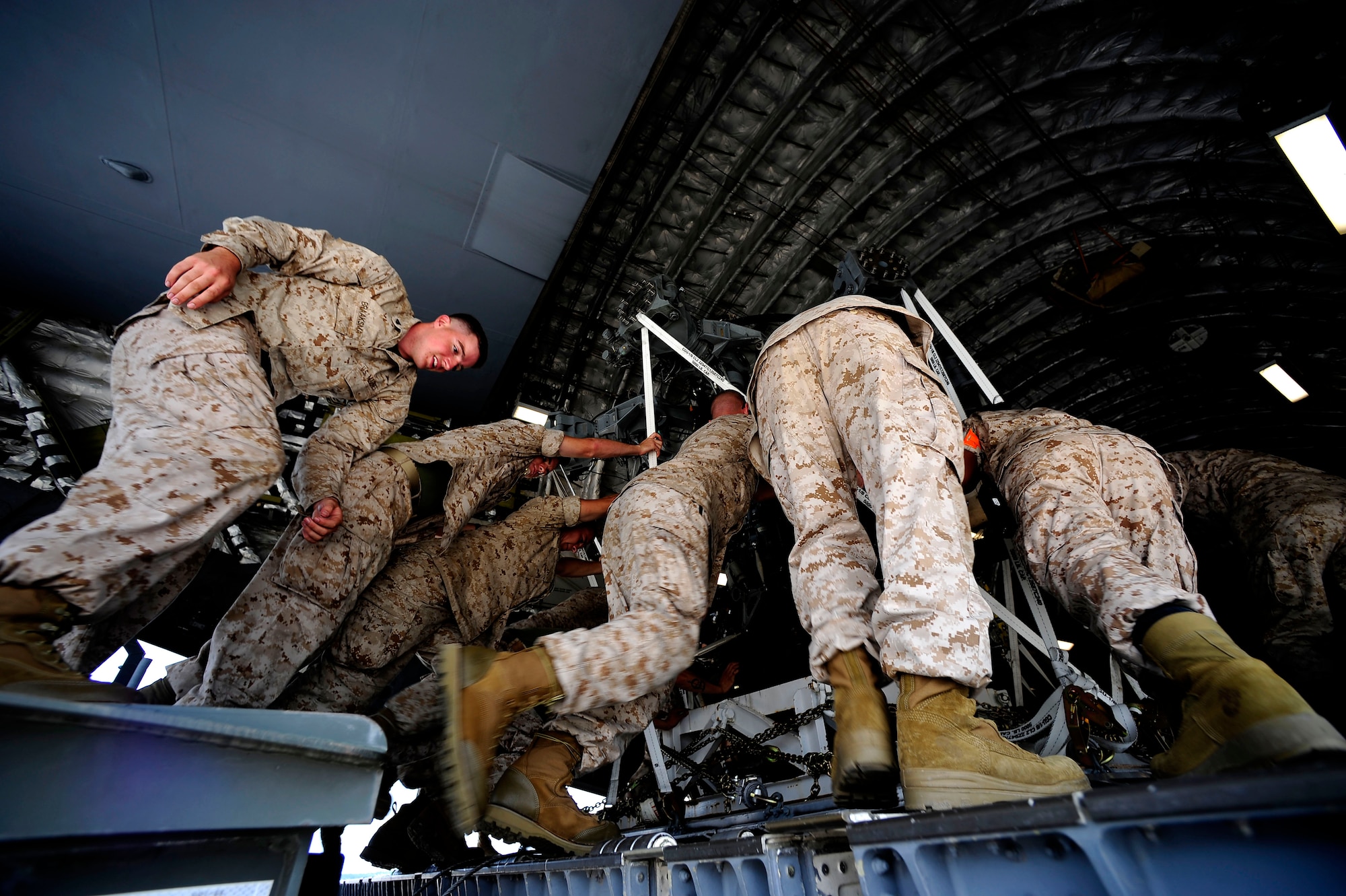 U.S. Marines assigned to the 26th Marine Expeditionary Unit (MEU) Marine Corps Air Station Cherry Point, N.C., along with U.S. Air Force members assigned to the 14th Air Lift Squadron, Joint Base Charleston, S.C. move a CH-53E Super Stallion onto a C-17 Globemaster III at Marine Corps Air Station Cherry Point, N.C., on August 20, 2010.  The helicopter is one of four that will be used to supplement U.S. military rescue and relief efforts in the flood affected areas of Pakistan.  (U.S. Air Force photo by Staff Sgt. Kamaile O. Long)