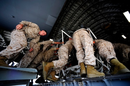 U.S. Marines assigned to the 26th Marine Expeditionary Unit (MEU) Marine Corps Air Station Cherry Point, N.C., along with U.S. Air Force members assigned to the 14th Air Lift Squadron, Joint Base Charleston, S.C. move a CH-53E Super Stallion onto a C-17 Globemaster III at Marine Corps Air Station Cherry Point, N.C., on August 20, 2010.  The helicopter is one of four that will be used to supplement U.S. military rescue and relief efforts in the flood affected areas of Pakistan.  (U.S. Air Force photo by Staff Sgt. Kamaile O. Long)