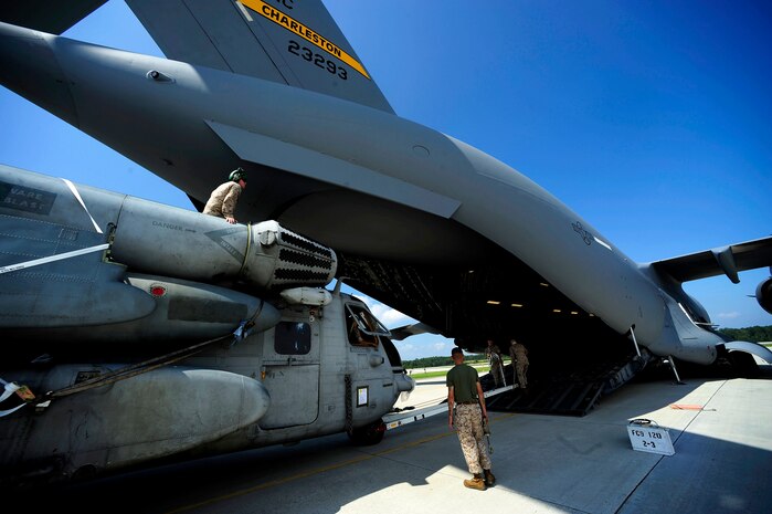 U.S. Marines assigned to the 26th Marine Expeditionary Unit (MEU) Marine Corps Air Station Cherry Point, N.C., along with U.S. Air Force members assigned to the 14th Air Lift Squadron, Joint Base Charleston, S.C. move a CH-53E Super Stallion onto a C-17 Globemaster III at Marine Corps Air Station Cherry Point, N.C., on August 20, 2010.  The helicopter is one of four that will be used to supplement U.S. military rescue and relief efforts in the flood affected areas of Pakistan.  (U.S. Air Force photo by Staff Sgt. Kamaile O. Long/Not Reviewed)

