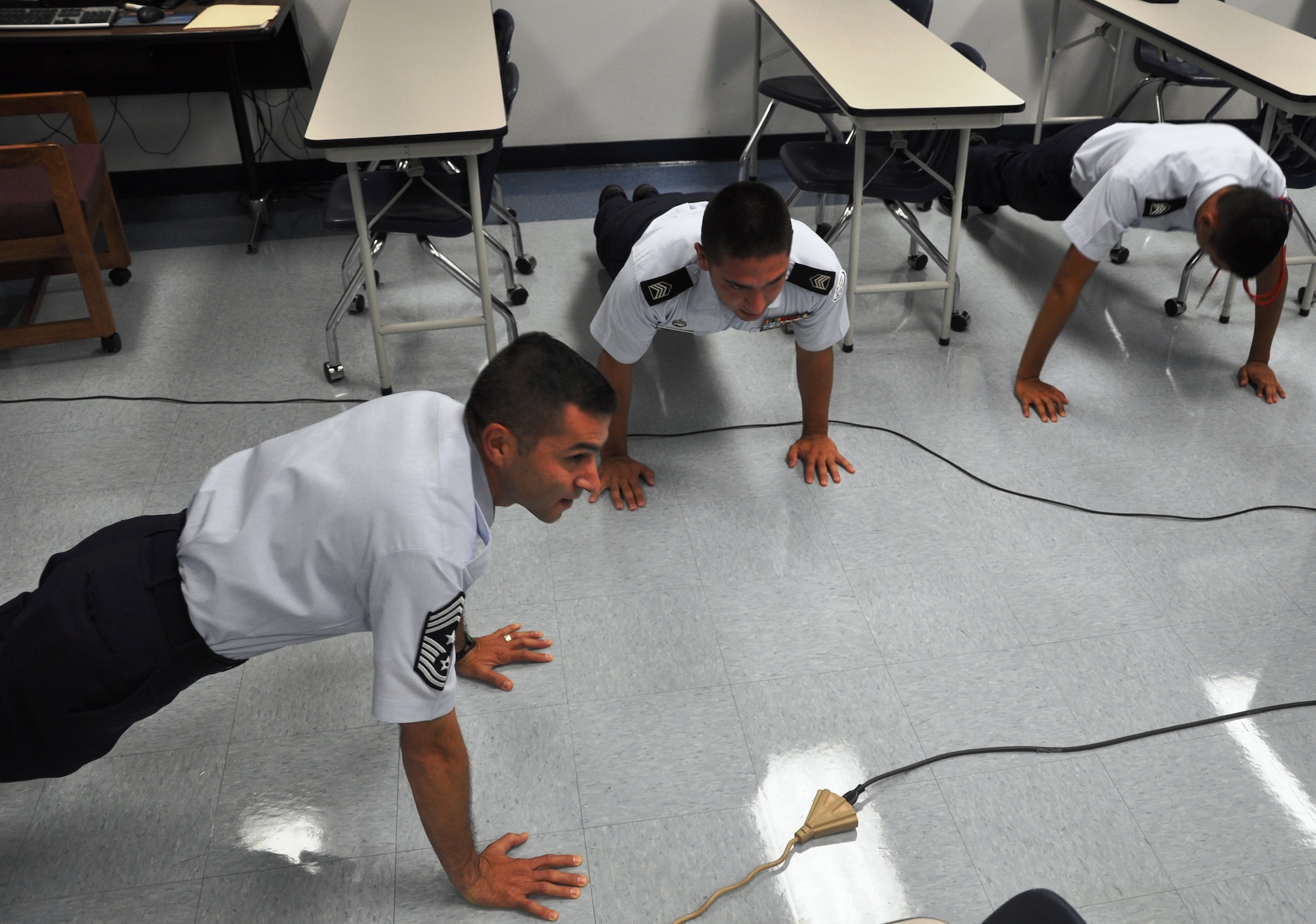 LAUGHLIN AIR FORCE BASE, Texas – Command Chief Master Sgt. Ruben Gonzalez, Air Force Recruiting Service command chief, leads the Del Rio chapter of Junior Reserve Officer Training Corp cadets in a set of pushups Aug. 19. Chief Gonzalez, who is from Eagle Pass and was recruited into the Air Force out of Del Rio in 1985, chose to begin his world-wide tour of AF recruiting stations with Del Rio. (U.S. Air Force photo by Airman 1st Class Blake Mize)