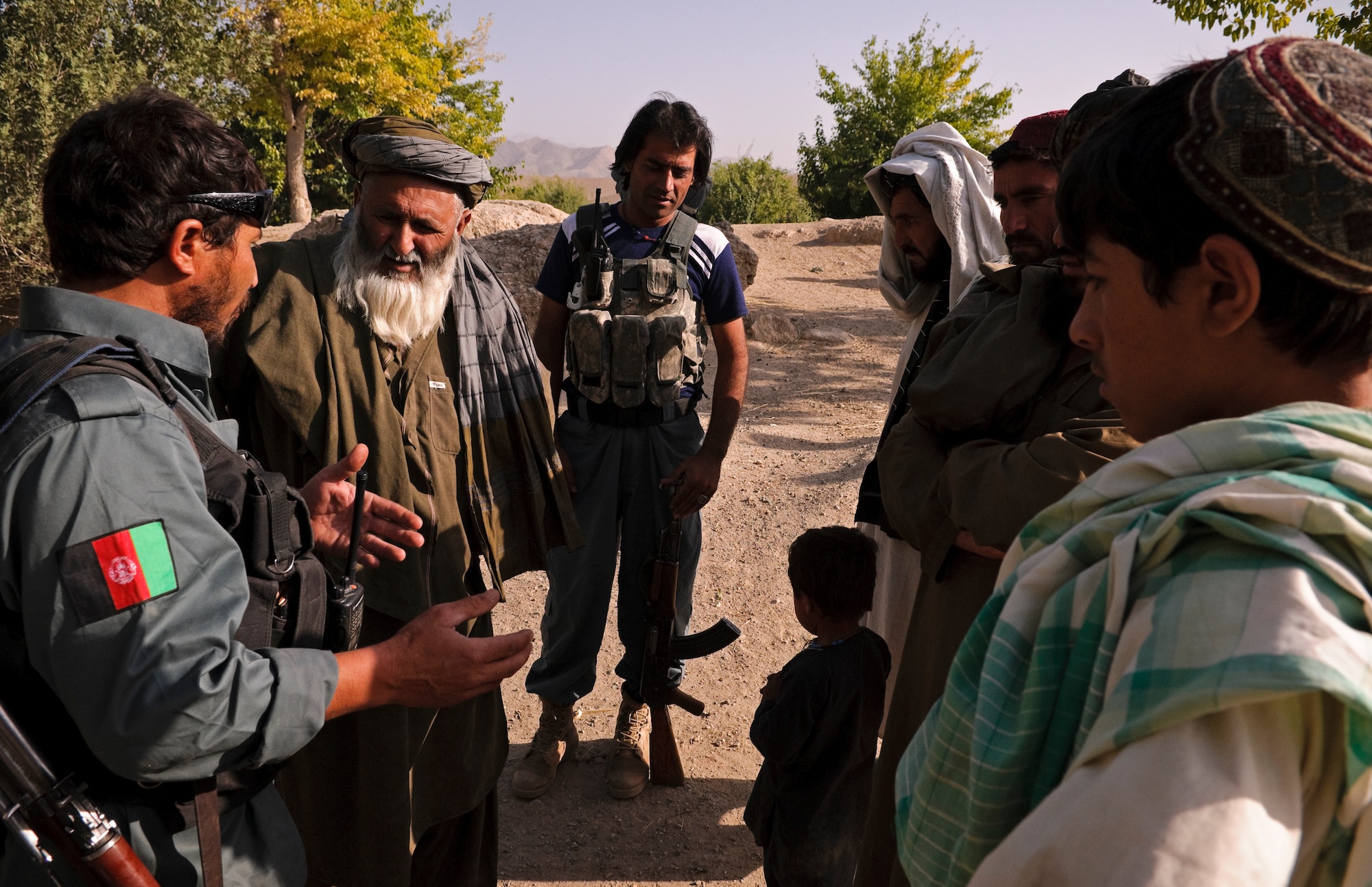 COMBAT OUTPOST MIZAN, Afghanistan - Members of the Afghan National Police speak to local villagers about the upcoming parliamentary elections in Afghanistan during a meeting in a village near Combat Outpost Mizan, Mizan District, Zabul province, Aug. 19, 2010. Members of Provincial Reconstruction Team Zabul and 3rd Platoon, Fox Company, 2nd Squadron, 2nd Stryker Cavalry Regiment, also spoke with the local population to assess their needs. (U.S. Air Force photo/Senior Airman Nathanael Callon/Released) 