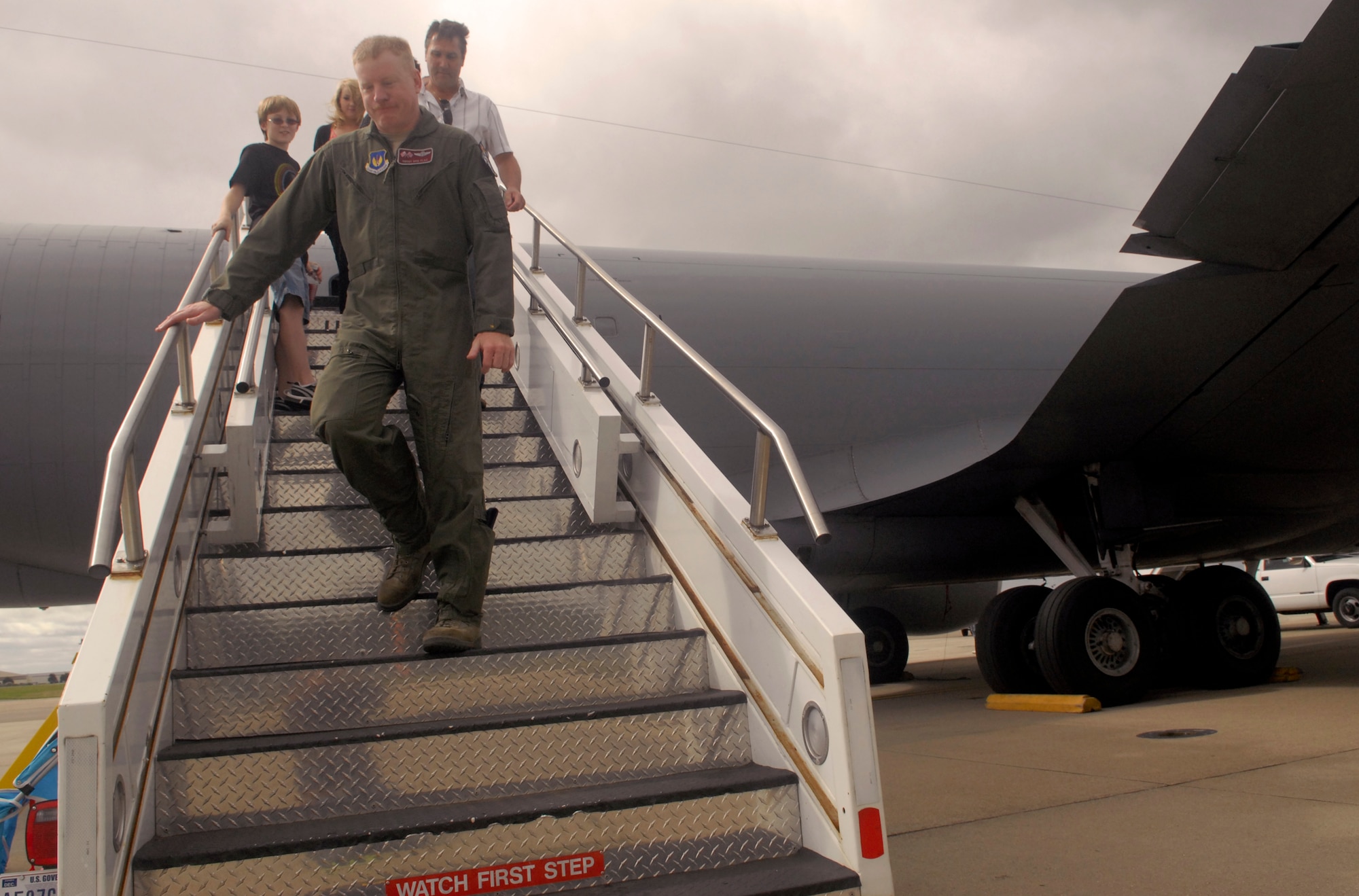 Senior Master Sgt. Opie Flax, 100th Operations Group, and the Fretwell Family from King's Lynn, Norfolk, descend stairs from a KC-135 Stratotanker static display during the 100th Civil Engineer Squadron open house Aug. 21, 2010. Sergeant Flax showed the family the KC-135 boom pod, then took them to the rear of the static display and explained how the refueling operations work, while pointing out specific Stratotanker components. (U.S. Air Force photo/Tech. Sgt. Kevin Wallace)
