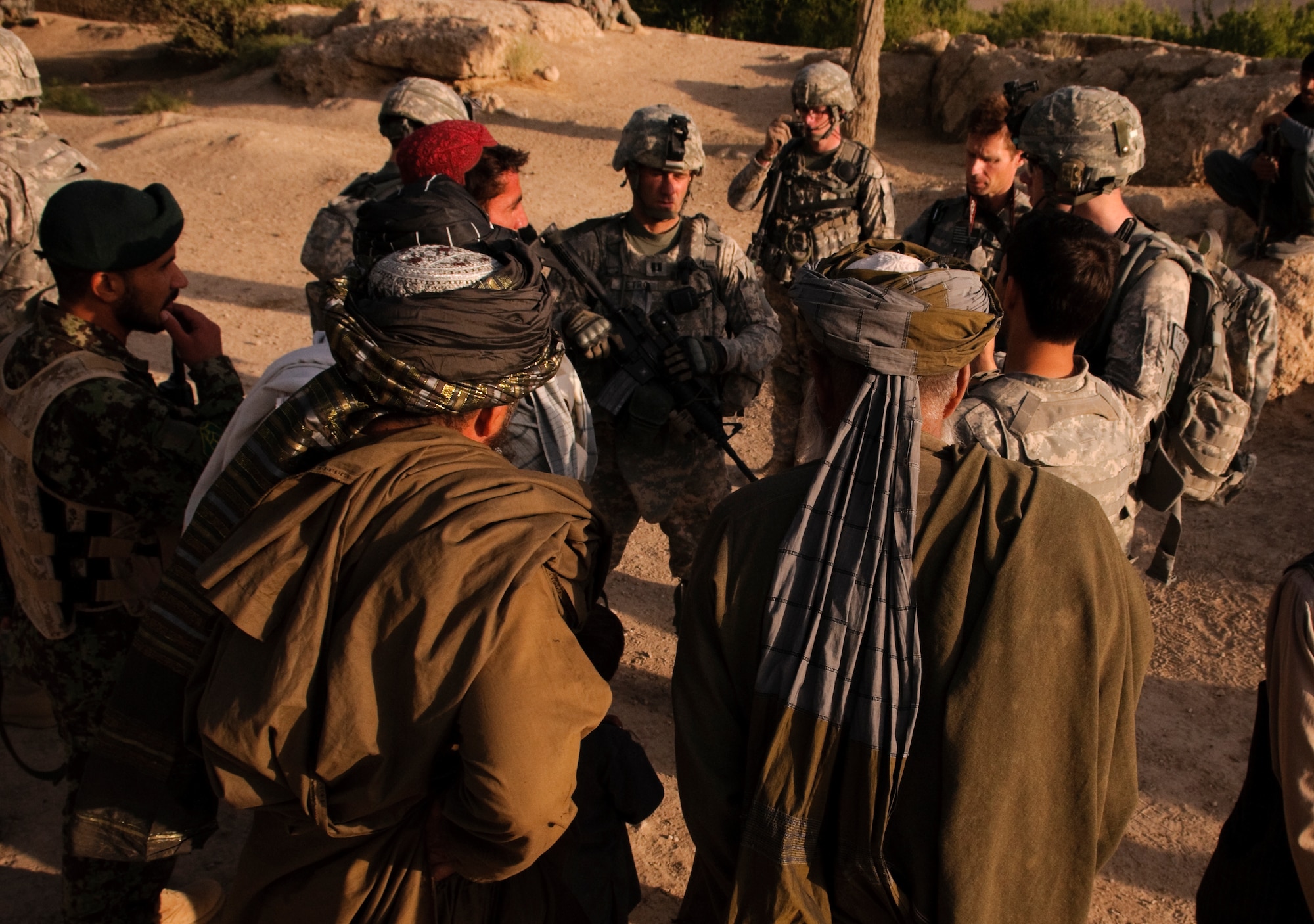COMBAT OUTPOST MIZAN, Afghanistan - Members of Provincial Reconstruction Team Zabul and 3rd Platoon, Fox Company, 2nd Squadron, 2nd Stryker Cavalry Regiment, speak with local elders during a meeting in a village near Combat Outpost Mizan, Mizan District, Zabul province, Aug. 19, 2010. The teams assessed the needs of the people and informed the local population of the upcoming provincial parliamentary elections. (U.S. Air Force photo/Senior Airman Nathanael Callon/Released)