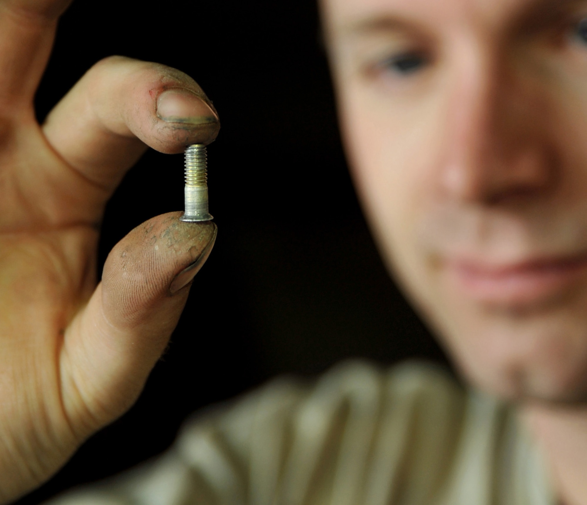 Staff Sgt. Aaron Martin, 332nd Expeditionary Maintenance Squadron Phase Inspection Section mechanic, displays one of the many fasteners used to hold together an F-16 Fighting Falcon, Aug. 9, 2010 at Joint Base Balad, Iraq. Phase inspections are thorough programs of preventative maintenance and inspection performed on the fighter jets every 400, 800 and 2,400 flying hours. Sergeant Martin is deployed from Shaw Air Force Base, S.C. (U.S. Air Force photo/Lt. Col. Robert Couse-Baker)