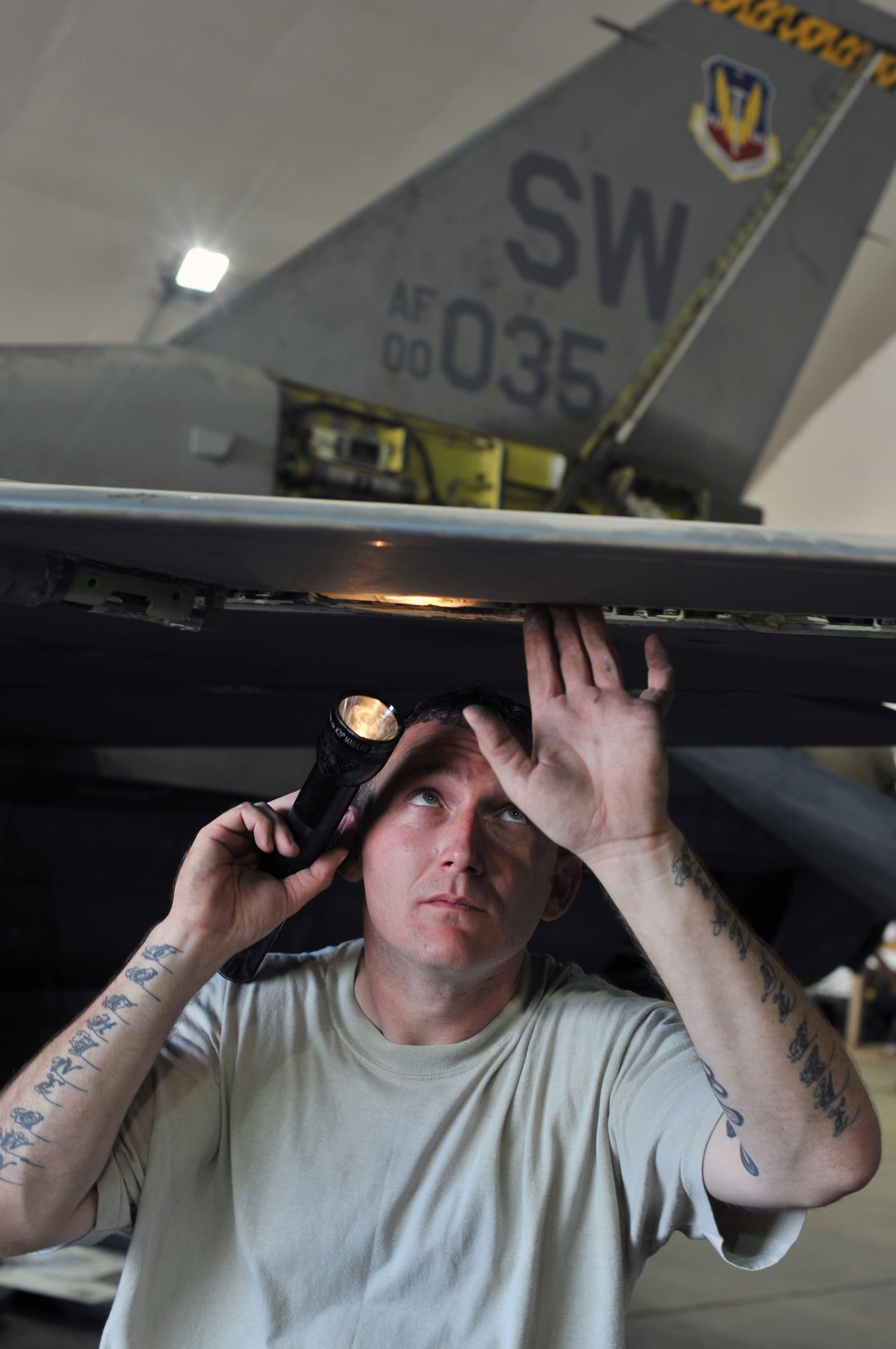 Staff Sgt. William Filyaw, 332nd Expeditionary Maintenance Squadron quality assurance inspector, performs a comprehensive visual check of an F-16 Fighting Falcon’s leading-edge flap at the end of a phase inspection Aug. 9, 2010 at Joint Base Balad, Iraq.  Phase inspections are thorough programs of preventative maintenance and inspection performed on F-16s every 400, 800 and 2,400 flying hours. Sergeant Filyaw and the aircraft are deployed from Shaw Air Force Base, S.C. (U.S. Air Force photo/Lt. Col. Robert Couse-Baker)