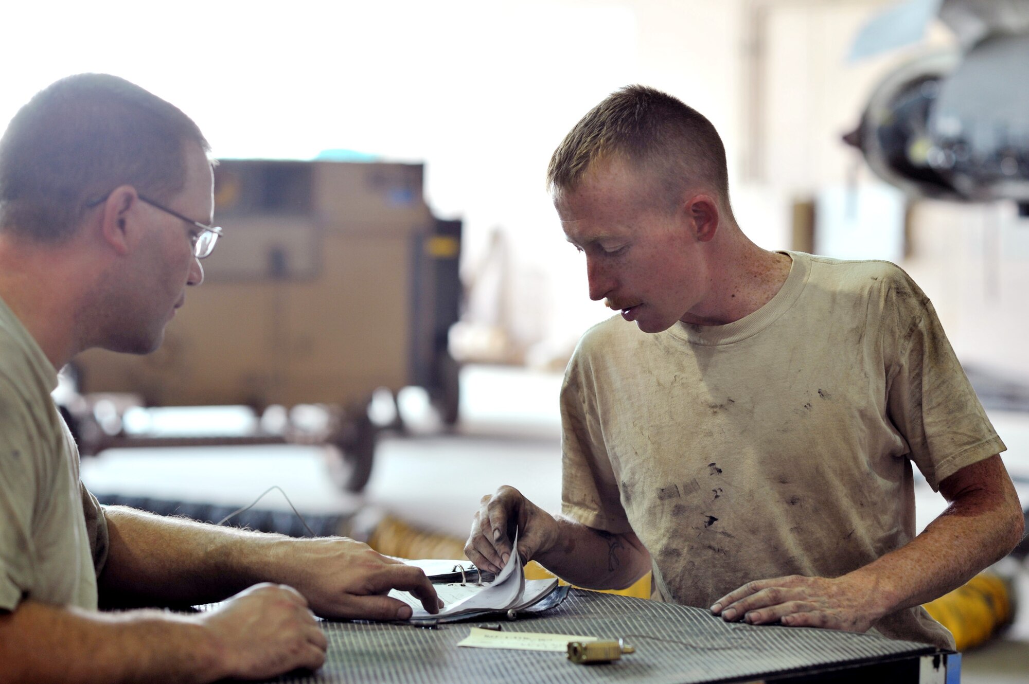 Tech. Sgt. Thomas Kennedy and Senior Airman Michael Schaefer, aircraft mechanics with the 332nd Expeditionary Maintenance Squadron Phase Section, review technical orders during a 400-hour phase inspection of an F-16 Fighting Falcon. Phase inspections are thorough programs of preventative maintenance and inspection performed on the multi-role fighter jets every 400, 800 and 2,400 flying hours. Sergeant Kennedy, Airman Schaefer and the F-16 are deployed from Shaw Air Force Base, S.C. (U.S. Air Force photo/Lt. Col. Robert Couse-Baker)