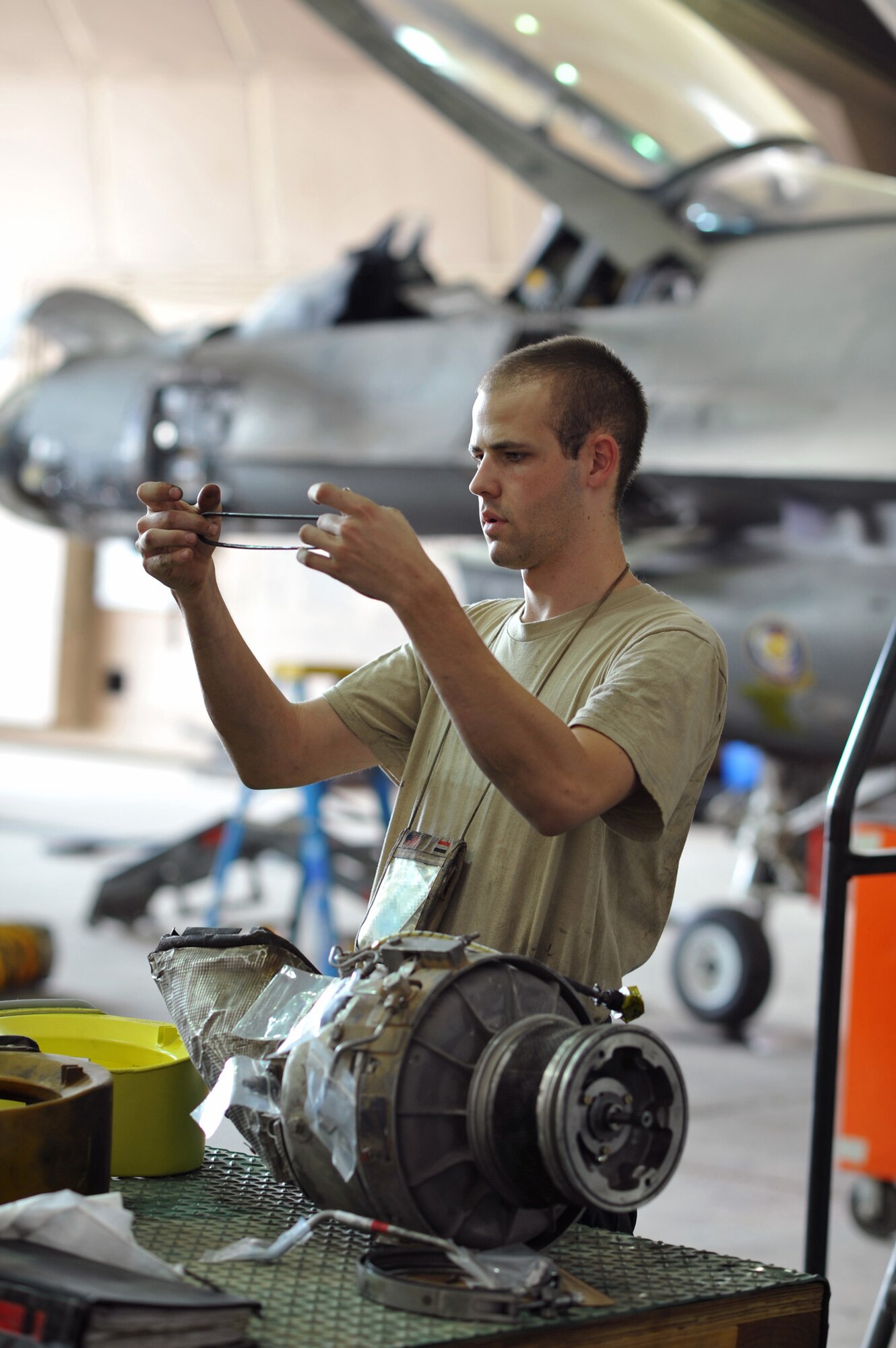 Airman 1st Class Spencer Donnellan, 332nd Expeditionary Maintenance Squadron Phase Inspection Section aircraft mechanic, compares a new inlet duct gasket with an old one during periodic maintenance on an F-16 jet fuel starter Aug. 7, 2010 at Joint Base Balad, Iraq. The work was performed as part of the periodic 400-hour serving of the aircraft.  Phase inspections are thorough programs of preventative maintenance and inspection performed on the multi-role fighter jets every 400, 800 and 2,400 flying hours. Airman Donnellan and the F-16 are deployed from Shaw Air Force Base, S.C. (U.S. Air Force photo/Lt. Col. Robert Couse-Baker)