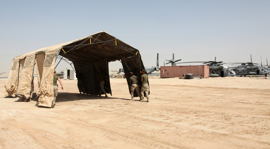 Marines from 3rd Marine Aircraft Wing (Forward), move a tent into position for a temporary site set up here Aug. 21. The Marines prepared the site for an incoming detachment from Marine Tiltrotor Squadron 266 (Reinforced), 26th Marine Expeditionary Unit. VMM-266 (Rein) will use the site to re-assemble four CH-53E Super Stallions, which they will use for humanitarian relief efforts in Pakistan.