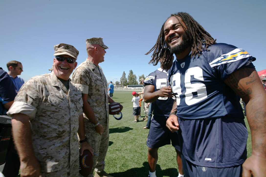 Maj. Gen. Thomas L. Conant, the commanding general of the 3rd Marine Aircraft Wing, spends time with Travis Johnson, a defensive end with the San Diego Chargers, during the 4th Annual Military Appreciation Day at the Miramar Youth Sports Complex Aug. 20. During the event, the Chargers had a walk through practice for their preseason game against the Dallas Cowboys Aug. 21.