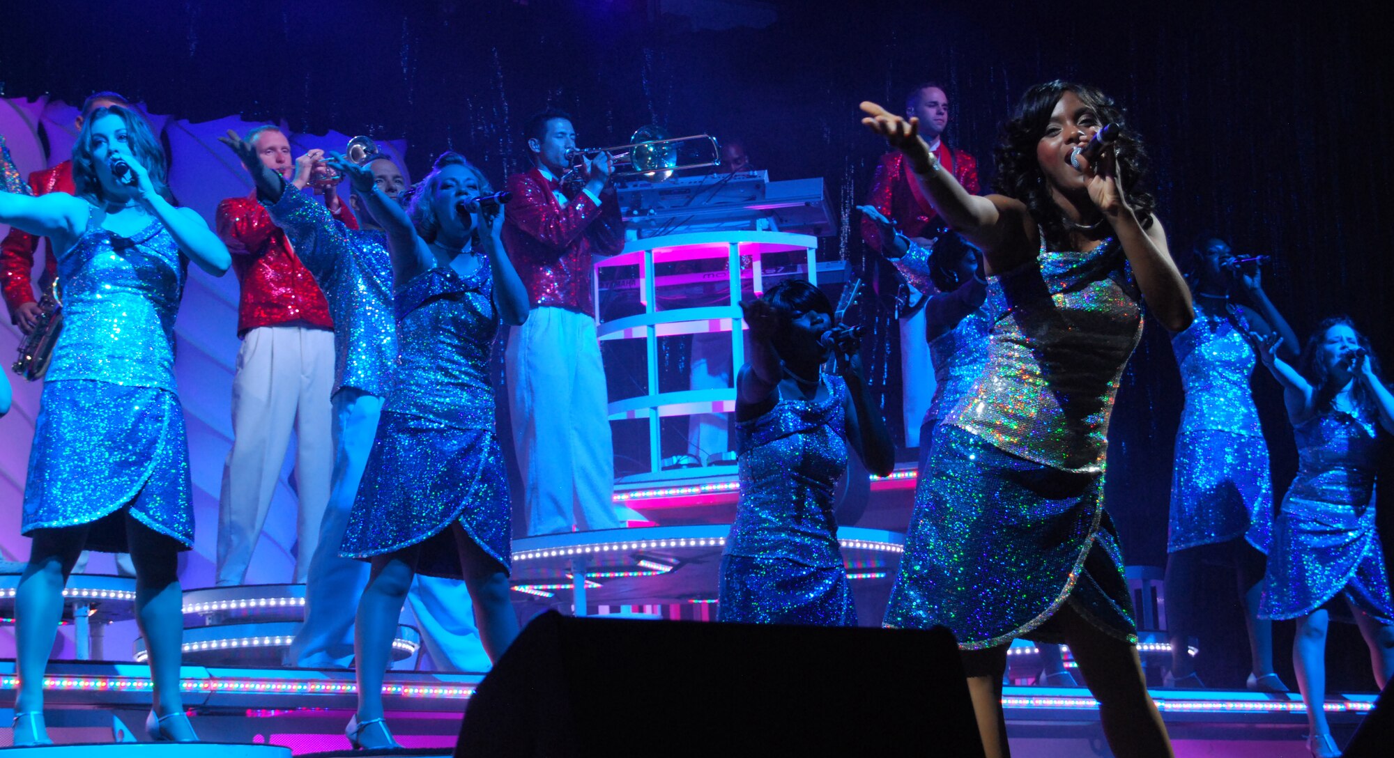 Staff Sgt. Candice Fagan (right, foreground) leads a Tops in Blue song during the group's concert in the Air Force Academy's Arnold Hall Theater Aug. 22, 2010. Sergeant Fagan is a native of Waldorf, Md., and an intelligence analyst with the 82nd Reconnaissance Squadron at Kadena Air Base, Japan. (U.S. Air Force photo/Staff Sgt. Don Branum)