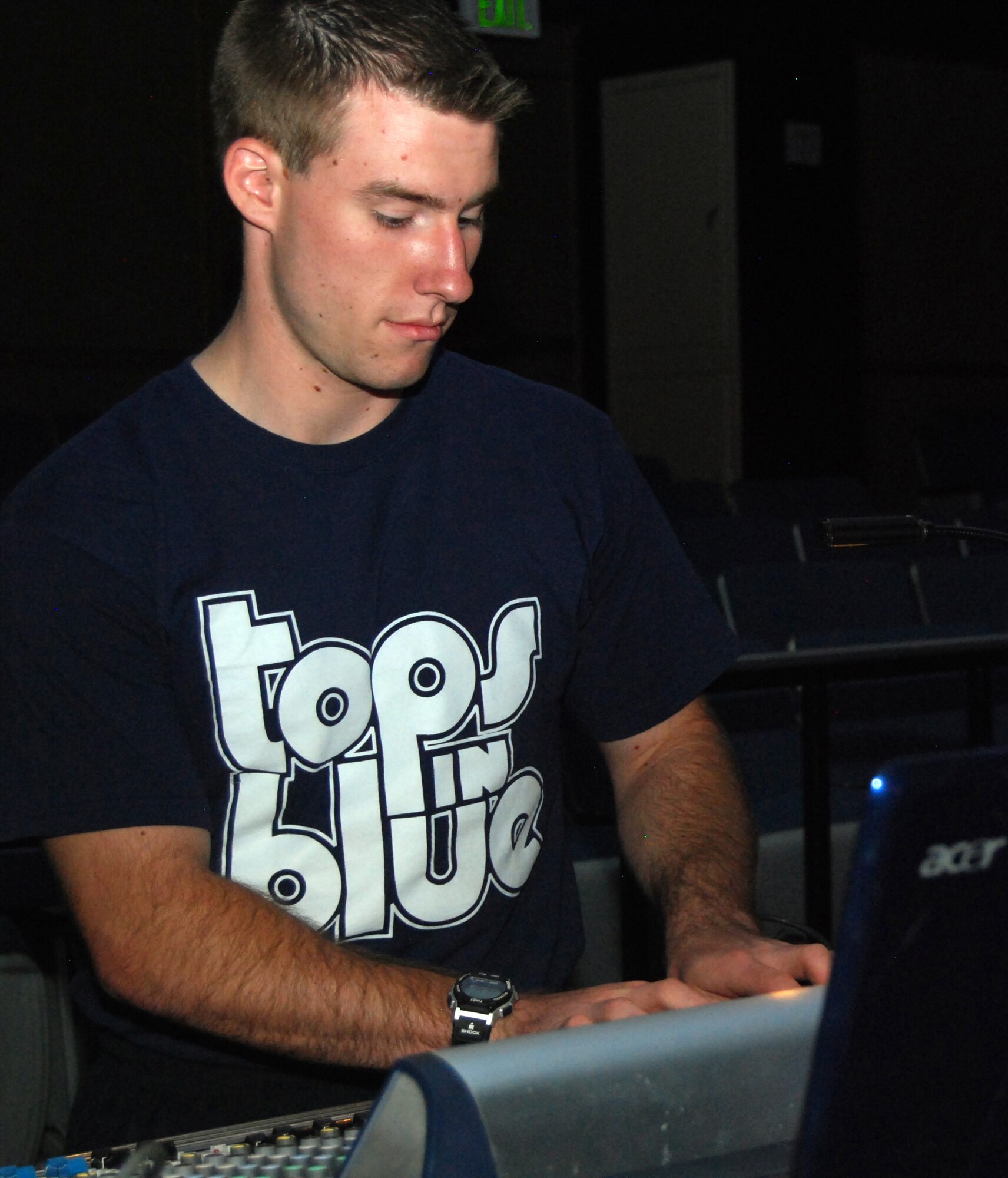 Airman 1st Class William Anger adjusts sound levels for Tops in Blue performers prior to the group's show in the Air Force Academy's Arnold Hall Theater Aug. 22, 2010. Airman Anger, a Denver native and C-17 Globemaster III crew chief stationed at Dover Air Force Base, Del., is the group's audio engineer. (U.S. Air Force photo/Staff Sgt. Don Branum)