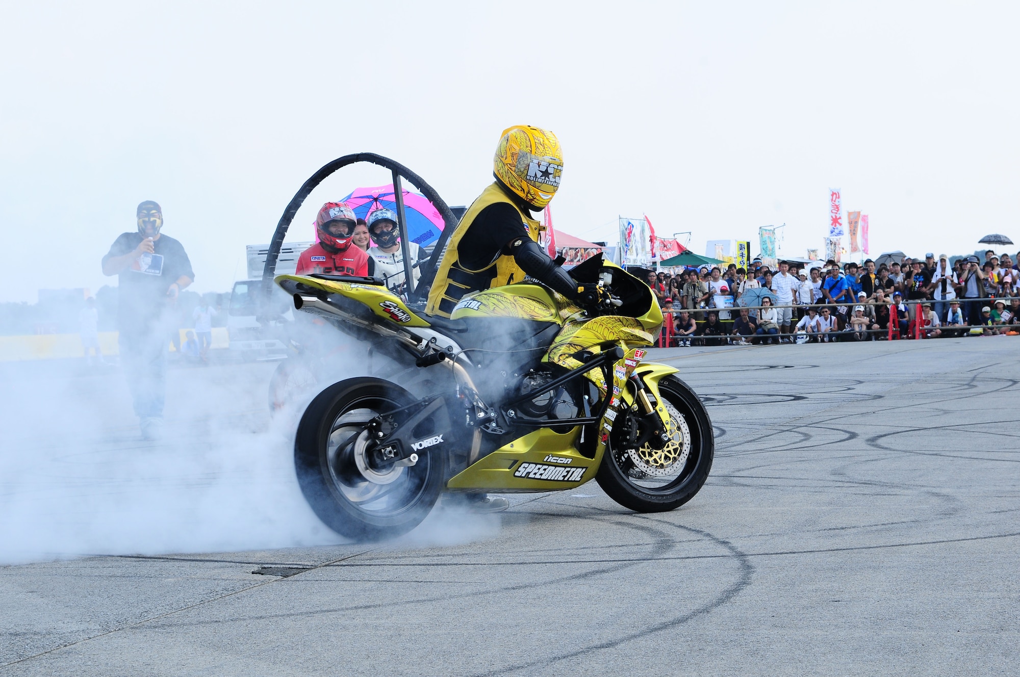 YOKOTA AIR BASE, Japan -- A member from No Limit Japan, a stunt bike group, performs a burn out Aug. 21 during the 2010 Yokota Air Base Japanese-American Friendship Festival. (U.S. Air Force photo/Airman 1st Class Sean Martin)