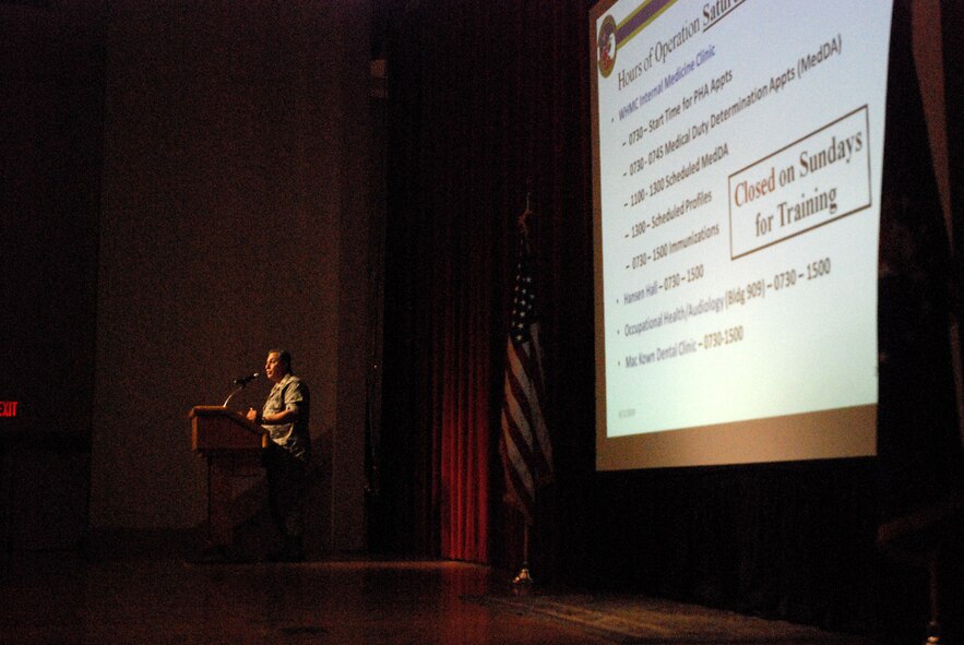 Members of the 433rd Airlift Wing gather at the Bob Hope Theater on Lackland Air Force Base, Texas, for a commander's call during the B Unit Training Assembly. The semi-annual commander's call is a wing-wide gathering to present awards, information, upcoming events and gather feedback. Maj. Richard Aves, from the 433rd Airlift Wing's dental section, tells Alamo Wing Airmen about when dental and physical examinations are due as part of their readiness training. (U.S. Air Force photo/Airman 1st Class Brian McGloin)