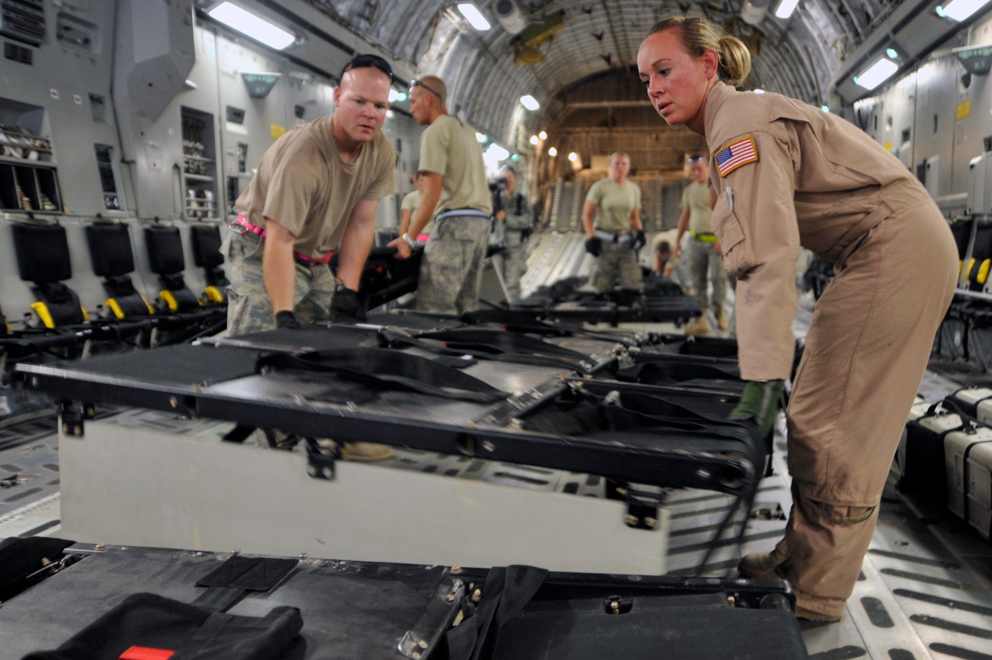 Tech. Sgt. Lindy Snodgrass, C-17 Globemaster III loadmaster and Tech. Sgt. Jonathan Bronson 447th Expeditionary Logistics Readiness Squadron aerial porter, put passenger seats together on a C-17 Globemaster III, Aug. 10, 2010, at Sather Air Base, Iraq. C-17 loadmasters and Airmen from the 447th ELRS unloaded 12 pallets of cargo, and then reconfigured the aircraft to carry passengers in less than an hour. The C-17 is redeploying personnel in support of The U.S. Forces Responsible Drawdown of Forces to 50,000 troops by the end of August when Operation Iraqi Freedom ends, and Operation New Dawn begins. ( U.S. Air Force photo by Senior Airman Perry Aston) (Released)