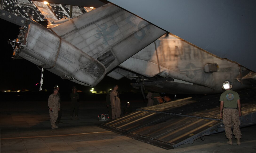 Marines from Marine Heavy Helicopter Squadron 361, 3rd Marine Aircraft Wing (Forward), monitor the clearance of a CH-53E Super Stallion as it is unloaded from an Air Force C-17 cargo plane Aug. 22. The helicopter is one of four that Marines from Marine Medium Tiltrotor Squadron 266 (Reinforced), 26th Marine Expeditionary Unit, will use to aid with relief efforts in Pakistan. Marines from 3rd MAW (Fwd) set up tents, communication abilities and made space for the extra helicopters to support the 26th MEU's relief efforts.