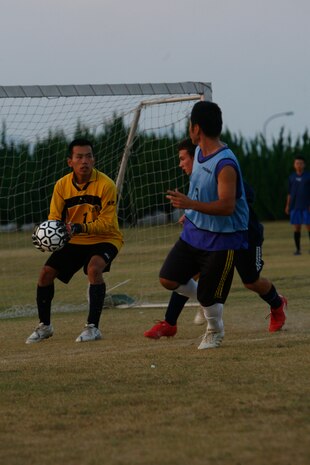 NAFY’s goalie clenches onto a ball tightly after a counter-assault by the Orient Tigers during the intramural soccer championship held at Penny Lake Fields here Aug. 20. Although NAFY fought fiercely, the Orient Tigers clenched the championship 5-2.