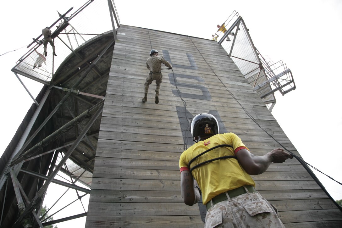 Sgt. Cornell Parks, a drill instructor with Platoon 2076, Fox Company, 2nd Recruit Training Battalion, helps keep a recruit stable as he rappels from the 47-feet rappel tower aboard Marine Corps Recruit Depot Parris Island, S.C., Aug. 22, 2010.