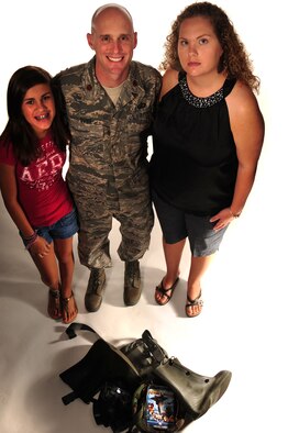 ELLSWORTH AIR FORCE BASE, S.D. – Maj. Erik Dunn, 28th Comptroller Squadron commander, and his family gather around deployment gear, Aug. 18.  Major Dunn’s wife, Deanna, is a 28th CPTS key spouse who focuses on the Heart link program.  Heart Link is a spouse orientation program geared toward strengthening military families and enhancing mission readiness. (U.S. Air Force photo/Senior Airman Corey Hook)