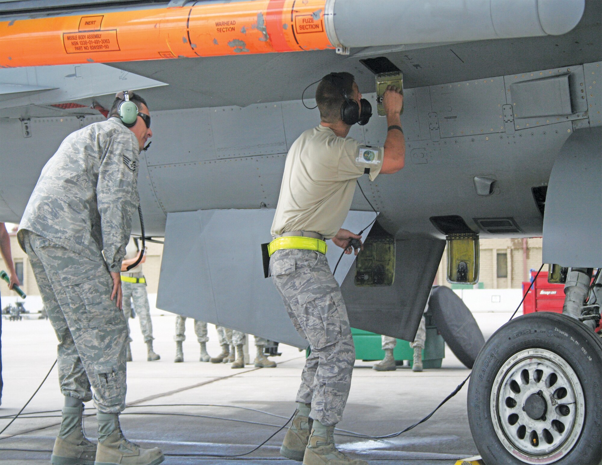 Staff Sgt. Alfonso Ramos III, F-16 Mission Ready Airman instructor, watches as a future crew chief works through step-by-step launch procedures before a sortie at Luke Air Force Base, Arizona.  (U.S. Air Force photo/Staff Sgt. Heather Dolar)