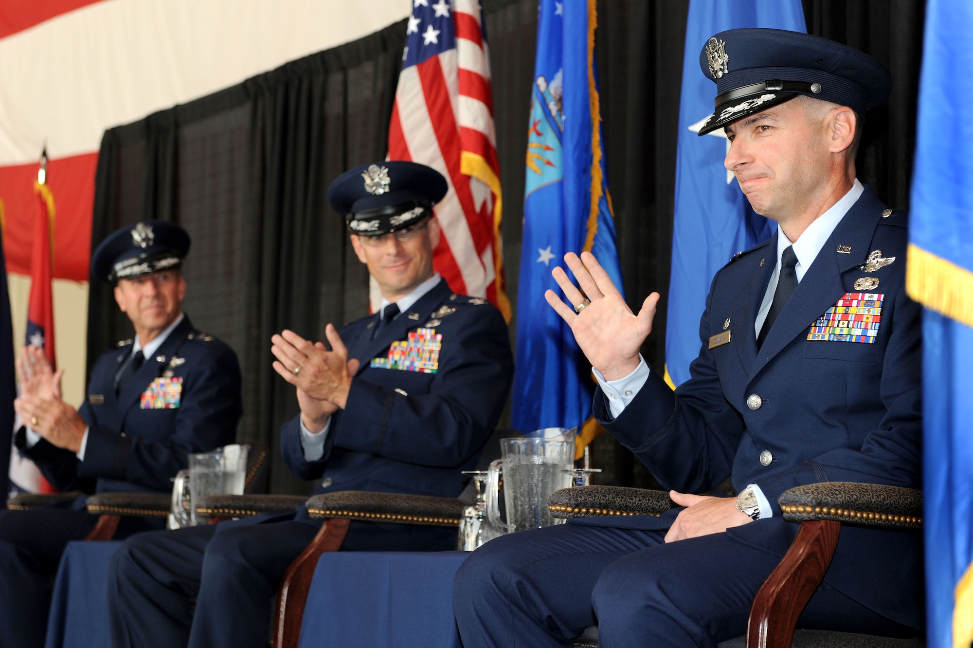 Maj. Gen. Mark S. Solo, 19th Air Force commander, and Col. Charles K. Hyde, welcome 314th Airlift Wing commander Col. Mark Czelusta during a change-of-command ceremony Aug. 20 on base. General Solo officiated the traditional ceremony, which is rooted deep in military history. (U.S. Air Force photo by Senior Airman Steele C. G. Britton)