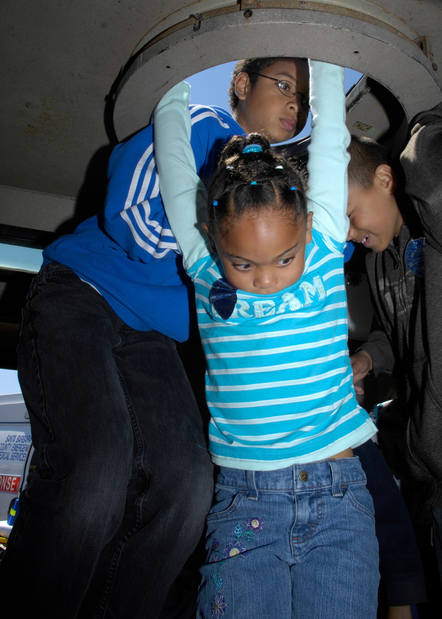 VANDENBERG AIR FORCE BASE, Calif. – Going topside, Jabari Davis with his sister Jahzara climb up the opening of the Lompoc Police Department’s armored vehicle at this year’s Touch-a-Truck event here Saturday, Aug. 21, 2010. Hosted by the 30th Force Support Squadron, Touch-a-Truck is an event that enables children to learn and operated various equipment used on or around base. (U.S. Air Force photo/Airman 1st Class Lael Huss)