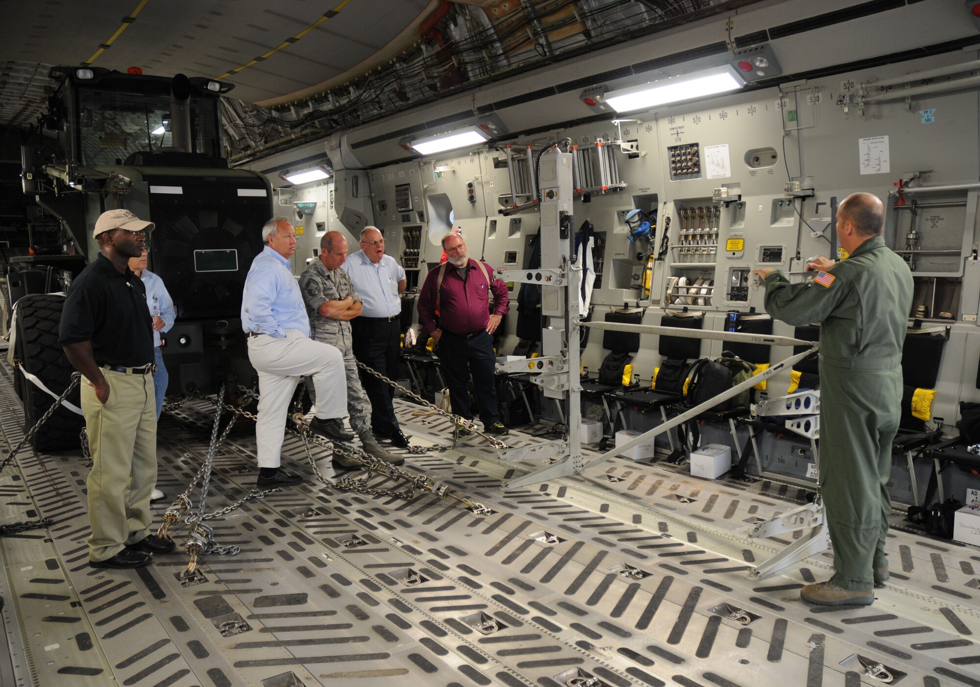 Senior Master Sgt. Jack McCracken, 3rd Airlift Squadron loadmaster, educates local civic leaders about the aermedical evacuation capabilities of the C-17 Globemaster III during the Honorary Commander orientation flight Aug. 16, 2010. Twenty-four civic leaders attended the flight, which featured a combat offload, tactical takeoff and aerial refueling. (U.S. Air Force photo/Capt. Marnee A.C. Losurdo)