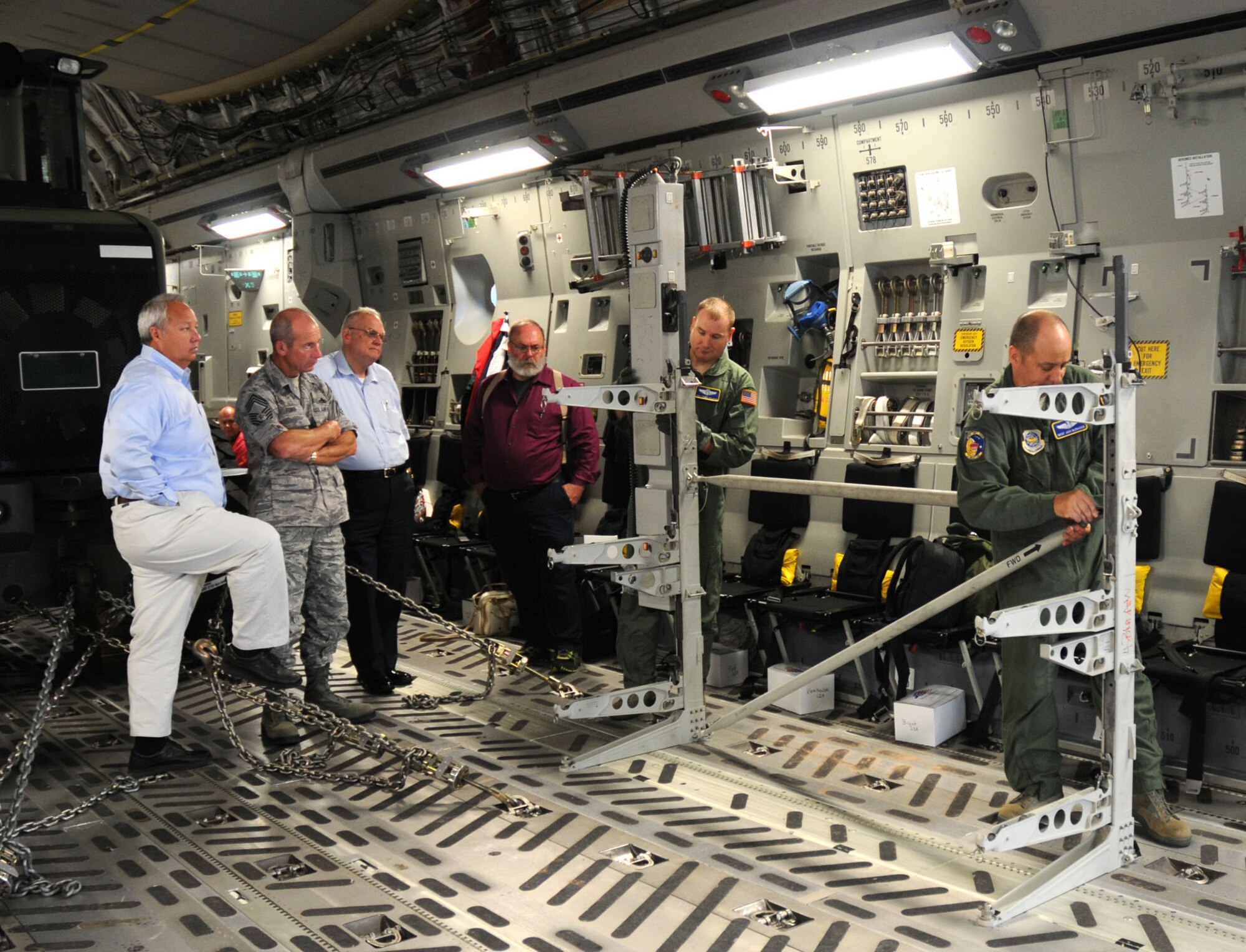 Senior Master Sgt. Jack McCracken (right) and Tech. Sgt. Donny Maheux, both 3rd Airlift Squadron loadmasters, set up a litter used for aermedical evacuations onboard a C-17 Globemaster III.  The demonstration was for the 24 local civic leaders attending the Honorary Commander orientation flight Aug. 16, 2010. The filght also featured a combat offload, tactical takeoff and aerial refueling. (U.S. Air Force photo/Capt. Marnee A.C. Losurdo)