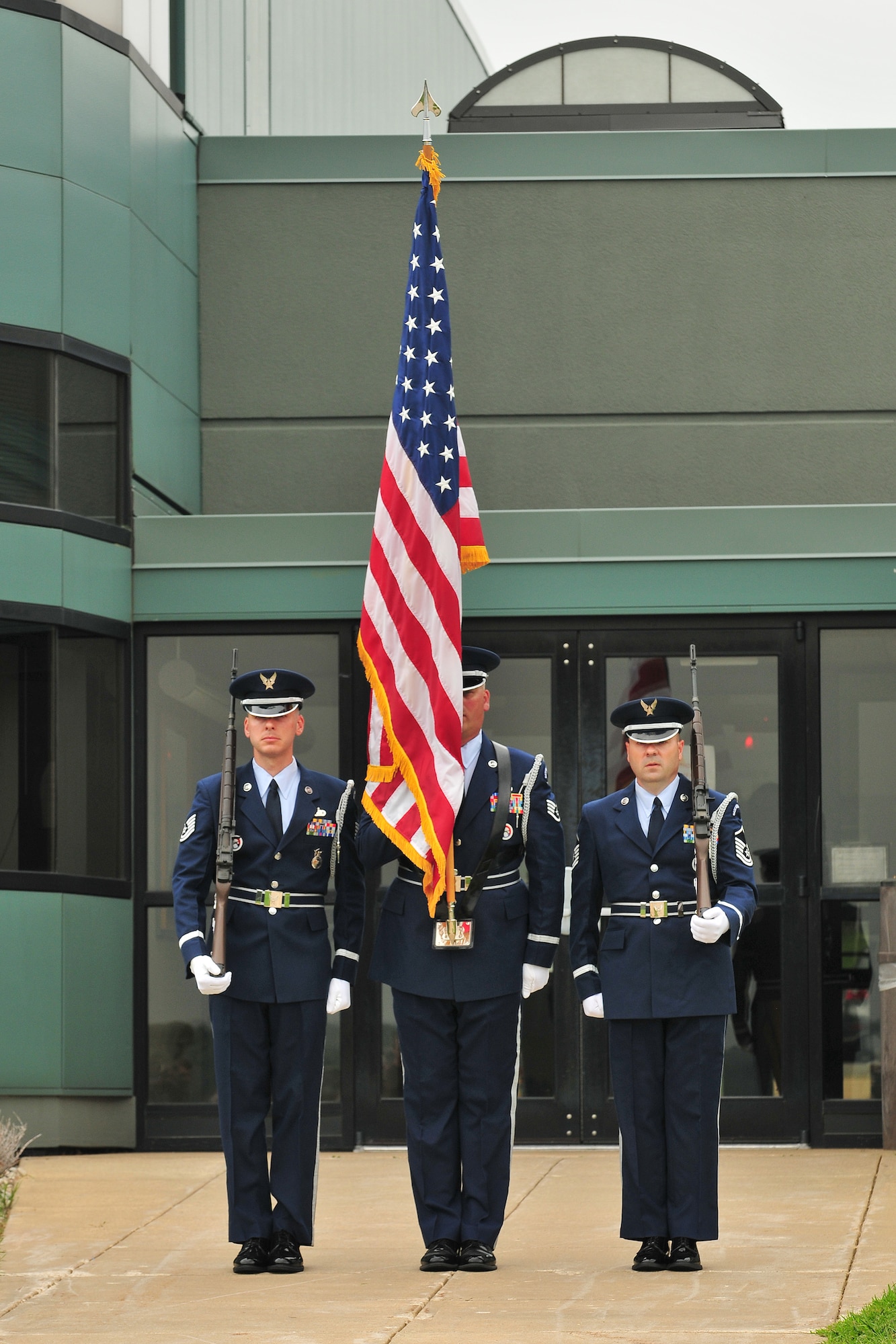 Volk Field honor guard team members Tech. Sgt. James Michaels, left, Staff Sgt. Robert Garrelts, center, and Master Sgt. Don Millbach present the colors at the 2010 Volk Field Air National Guard Base Open House on August 21, 2010. Despite inclement weather, the Volk Field Open house attracted approximately 3000 visitors, 20 military and civilian aircraft, numerous vendors, and aerial performers from across the country.