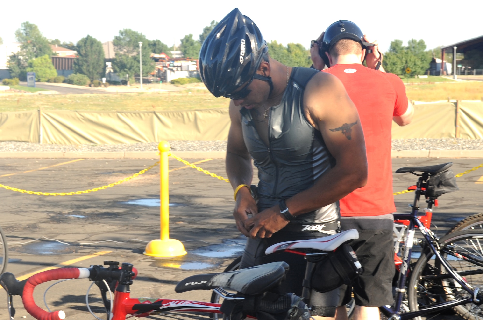 BUCKLEY AIR FORCE BASE, Colo. -- Marine Corps Staff Sgt. Albert Martinez gears up for the bike-riding portion of the Buckley Fit Fight Freedom Mini-Triathlon Aug 22. The bike ride was a total of 12.5 miles. (U.S. Air Force Photo by Airman Manisha Vasquez)