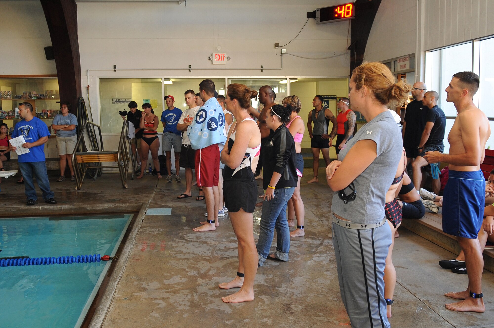 BUCKLEY AIR FORCE BASE, Colo.-- Members of Team Buckley receive a briefing about what challenges they will face during the Fit Fight Freedom Mini-Triathlon Aug. 22. The Triathlon consisted of three parts, a swim, bike ride and a run. (U.S. Air Force Photo by Airman Manisha Vasquez)