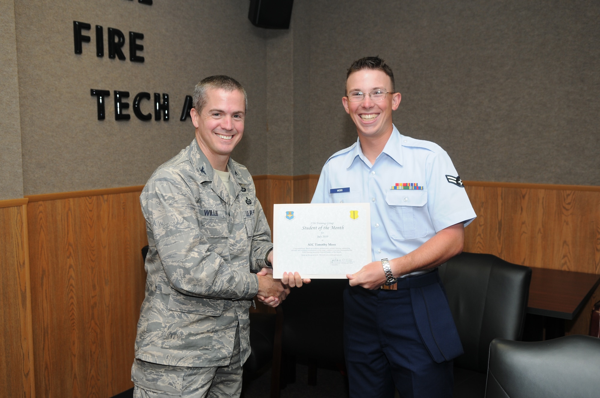 Airman 1st Class Timothy Moss, 315th Training Squadron, accepts his July Student of the Month award from Col. J.D. Willis, 17th Training Group commander. (U.S. Air Force photo/Airman 1st Class Clayton Lenhardt) 