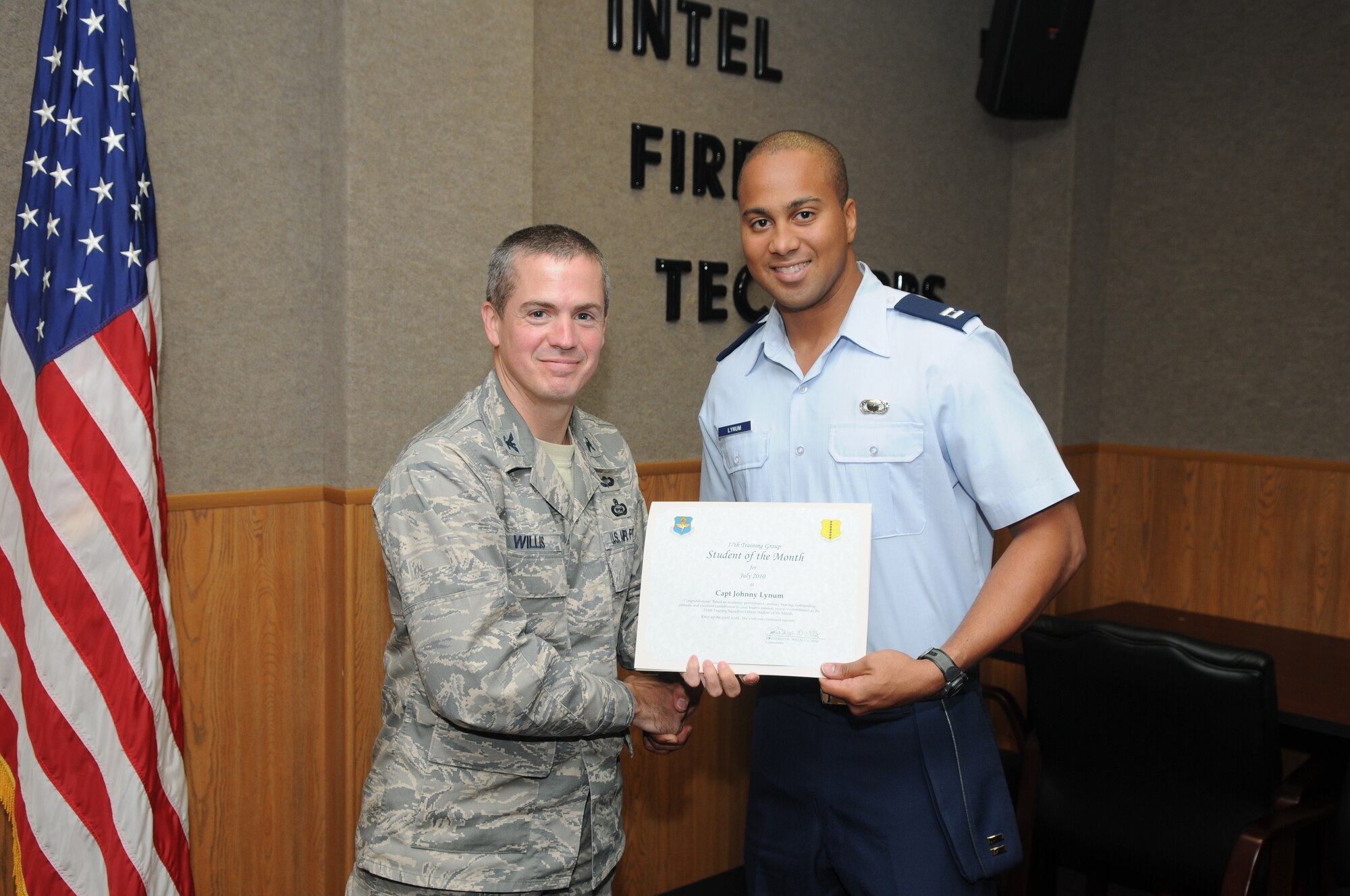 Capt. Johnny Lynum, 315th Training Squadron, accepts his July Student of the Month award from Col. J.D. Willis, 17th Training Group commander. (U.S. Air Force photo/Airman 1st Class Clayton Lenhardt) 
