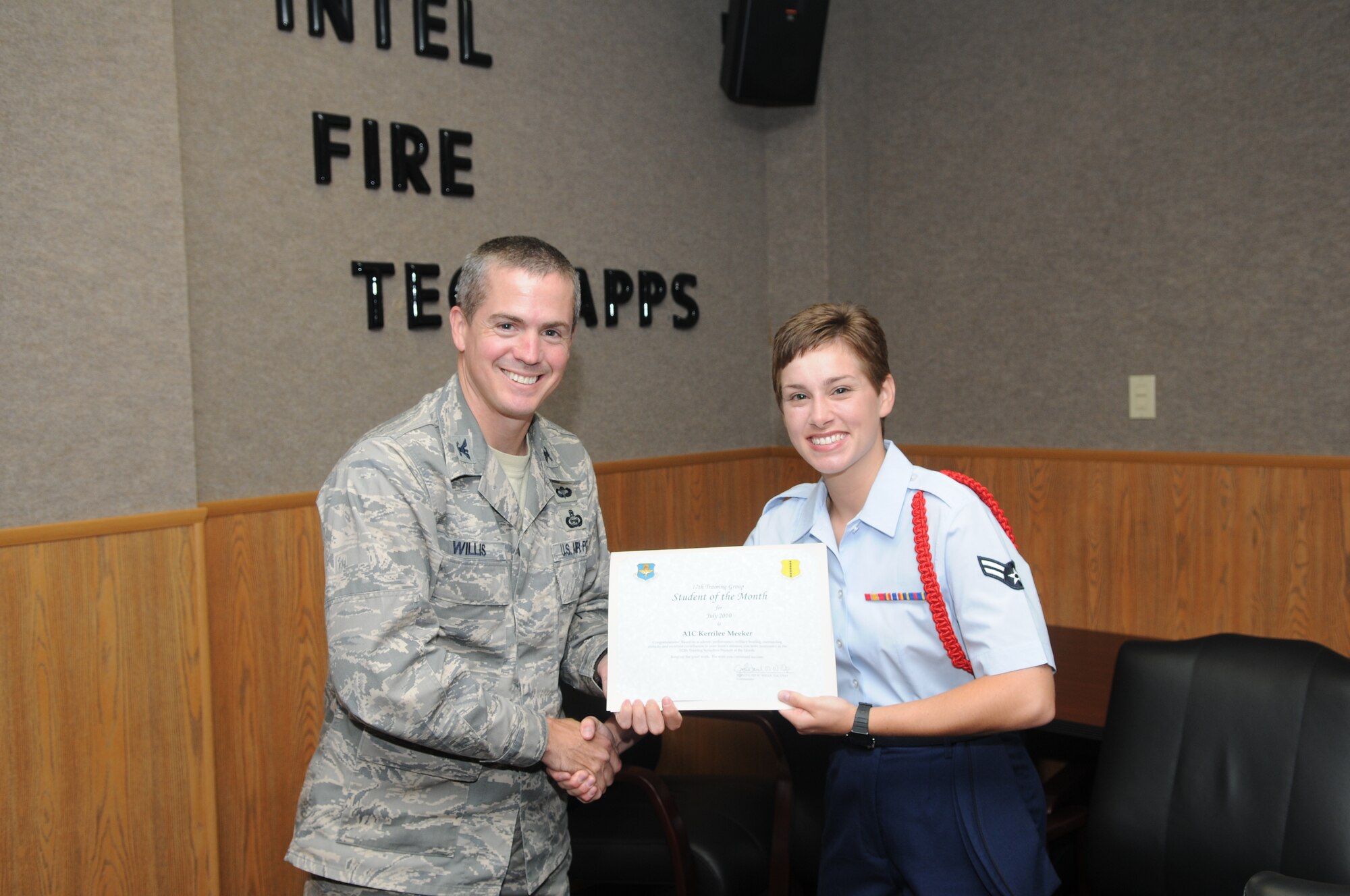 Airman 1st Class Kerrilee Meeker, 312th Training Squadron, accepts her July Student of the Month award from Col. J.D. Willis, 17th Training Group commander. (U.S. Air Force photo/Airman 1st Class Clayton Lenhardt) 