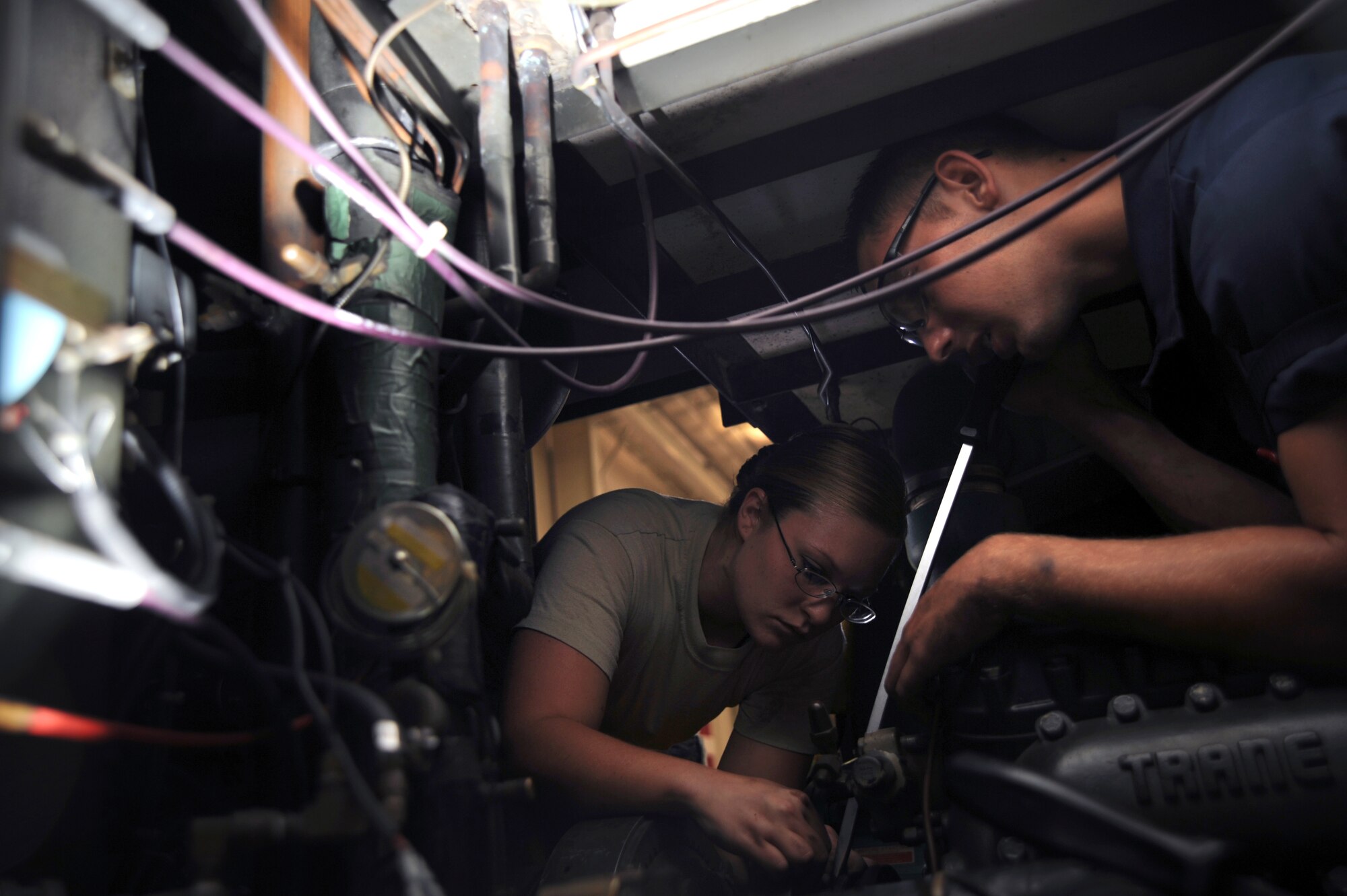WHITEMAN AIR FORCE BASE, Mo., -- Senior Airman Elizabeth Shook and Airman 1st Class John McLaughlin, 509th Maintenance Squadron Aerospace Ground Equipment technician, change the clutch on a 401 ACE air conditioner on August 18. AGE mechanics ensure the equipment is operational to support the daily missions here.
(U.S. Air Force photo/Staff Sgt. Jason Huddleston) (Released)