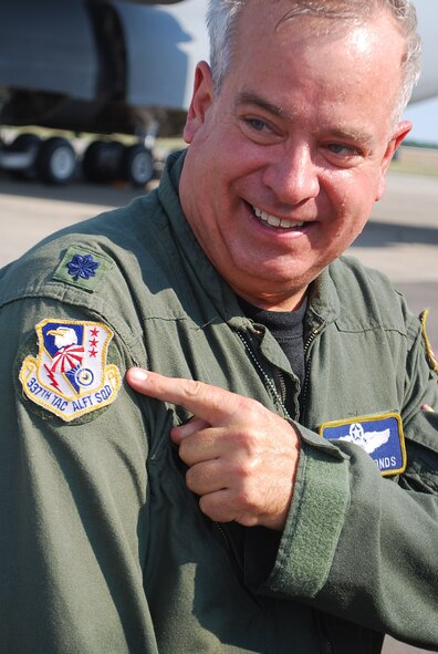 Lt. Col. Gregory Symonds points to his former C-130 flying squadron emblem, Aug. 19, following his last C-5 flight at Westover. Colonel Symonds is also the last pilot from the C-130 era of the wing, having flown the Hercules at Westover in the mid-1980s. (photo by Master Sgt. Andrew Biscoe)