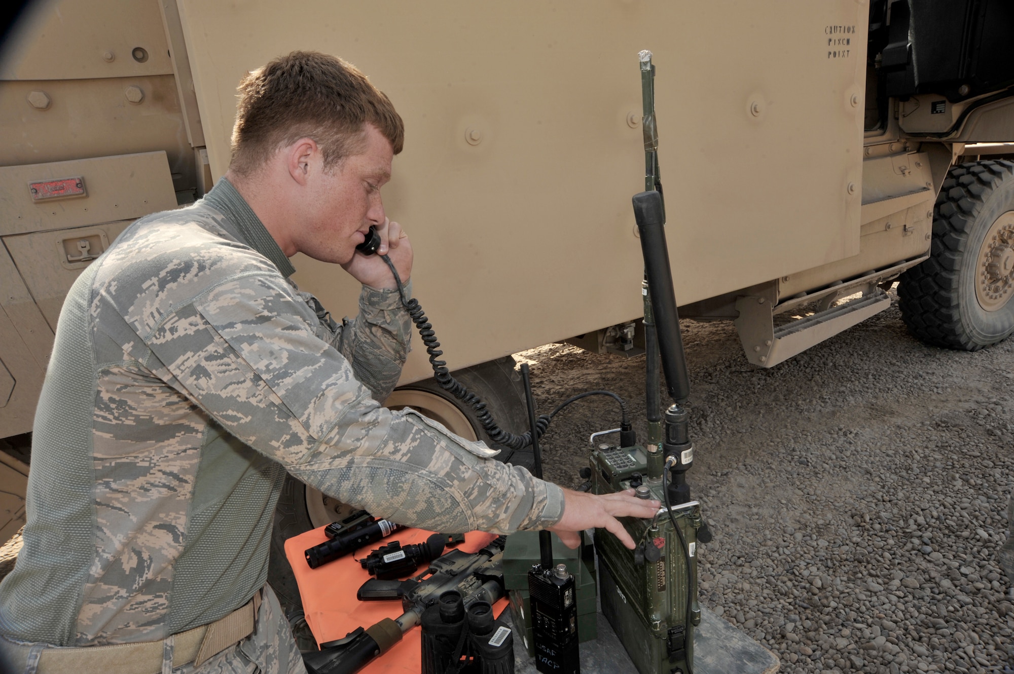 Senior Airman Donald McKee checks the operation of a radio Aug. 3, 2010, at Camp Liberty, Iraq. Tactical air control party Airmen are performing pre-combat checks and inspections, in preparation for supporting the Responsible Drawdown of Forces mission, the goal of which is to bring the number of operational forces down to 50,000 servicemembers. Airman McKee is an 82nd Air Support Operations Squadron, Det. 2 joint terminal attack controller. (U.S. Air Force photo/Senior Airman Perry Aston)