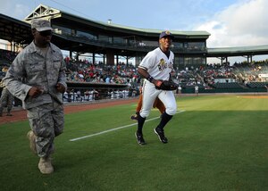 U.S. Air Force Staff Sgt. Michael Williams runs next to Deangelo Mack of the Charleston RiverDogs before the opening ceremonies for military appreciation night Aug. 19, 2010, at Joseph P. Riley, Jr. Park in Charleston, S.C. Sergeant Williams took to the field along with 13 other Air Force, Coast Guard and Navy servicemembers to be recognized with their families. Sergeant Williams is an air transportation craftsman with the 437th Aerial Port Squadron. (U.S. Air Force photo/Senior Airman Timothy Taylor)