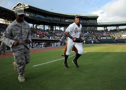 U.S. Air Force Staff Sgt. Michael Williams runs next to Deangelo Mack of the Charleston RiverDogs before the opening ceremonies for military appreciation night Aug. 19, 2010, at Joseph P. Riley, Jr. Park in Charleston, S.C. Sergeant Williams took to the field along with 13 other Air Force, Coast Guard and Navy servicemembers to be recognized with their families. Sergeant Williams is an air transportation craftsman with the 437th Aerial Port Squadron. (U.S. Air Force photo/Senior Airman Timothy Taylor)