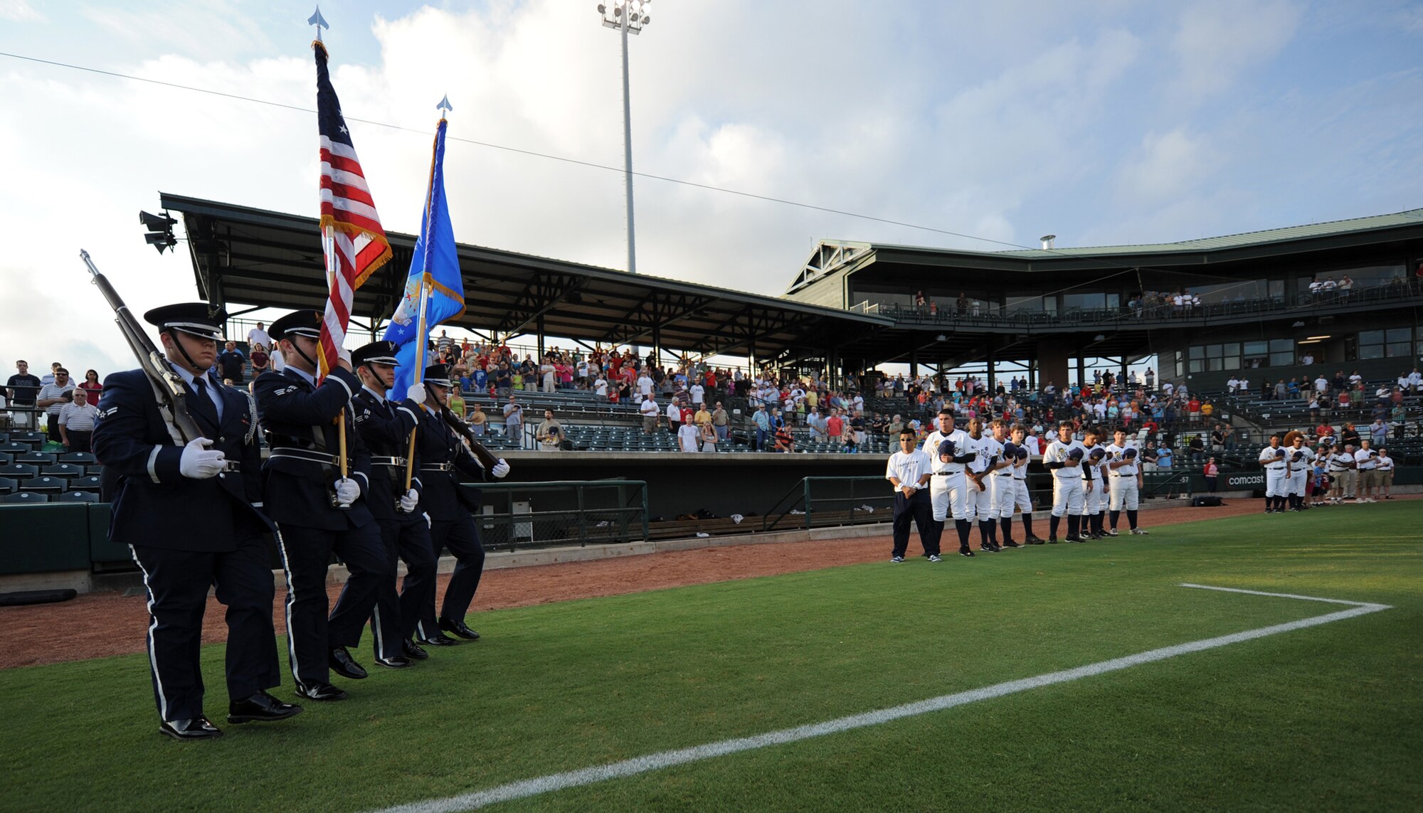 Members of the Joint Base Charleston Honor Guard march onto the Charleston RiverDogs baseball field to present the colors for the military appreciation night opening ceremony Aug. 19, 2010, at Joseph P. Riley, Jr. Park in Charleston, S.C. The RiverDogs and Force Protection, a local manufacturer of mine-resistant vehicles, joined together to recognize military members who've recently returned from deployment. The RiverDogs traditionally host two military appreciation nights a year and offer free tickets to servicemembers and their families. (U.S. Air Force photo/Senior Airman Timothy Taylor)
