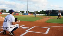 U.S. Air Force Col. Steven Chapman throws the opening pitch for the Charleston RiverDogs military appreciation night Aug. 19, 2010, at Joseph P. Riley, Jr. Park in Charleston, S.C. Before the start of the game, military members and their families took to the field with RiverDogs players for the presentation of the colors and the singing of the national anthem. Colonel Chapman is the commander of the 315th Airlift Wing and recently returned from deployment. (U.S. Air Force photo/Senior Airman Timothy Taylor)