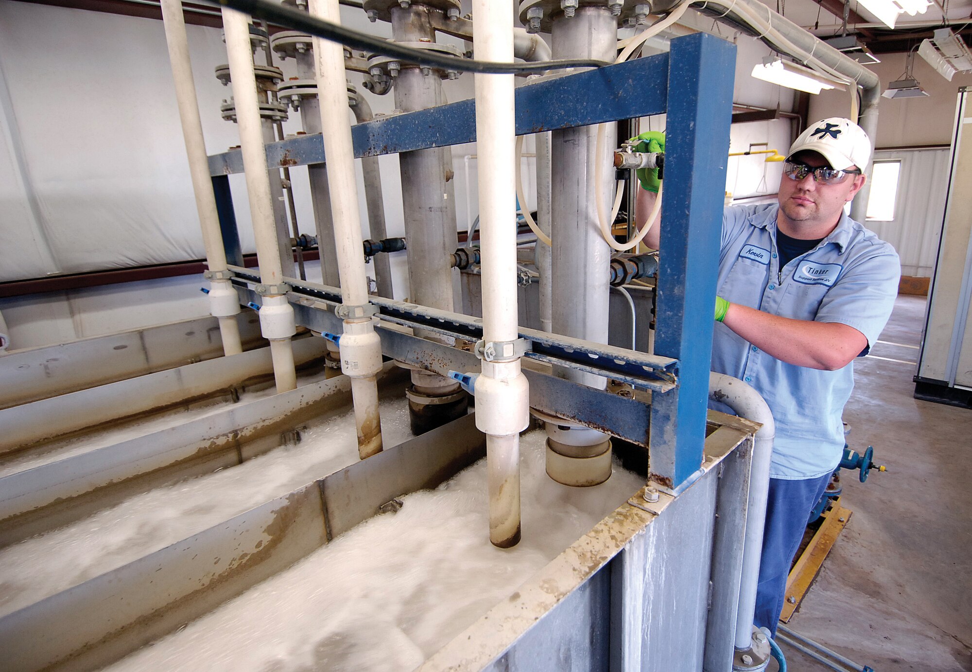 Kevin Smith monitors the air-sparged hydrocyclone in the treatment facility. Incoming waste water goes through four cleaning stages before going to the rest of the treatment plant. The machine has been a big success story for lowering metals in the waste water. The foaming is partially due to a pre-treat chemical.