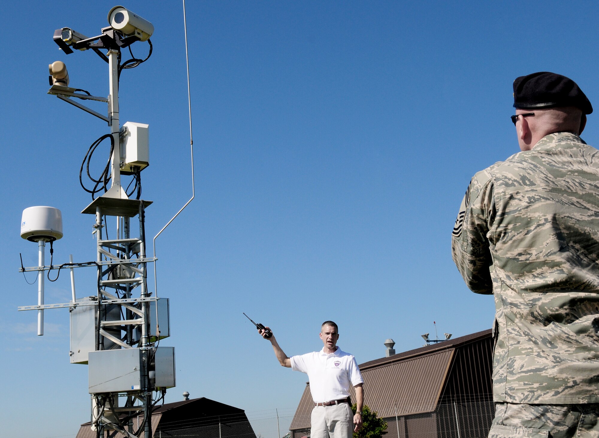 David Dykes provides tower information to Chief Master Sgt. Kevin Peters during a site tour of key components of the Joint Force Protection Advanced Secuirty System Aug. 20, 2010, at Spangdahlem Air Base, Germany. The system integrates advanced technology including Smart Car-sized robots, cameras, software and motion sensors with existing technology to increase force protection capabilities. Mr. Dykes is a JFPASS team member and Chief Peters is the U.S. Air Forces in Europe Security Forces Manager. (U.S. Air Force photo/Staff Sgt. Heather M. Norris)
