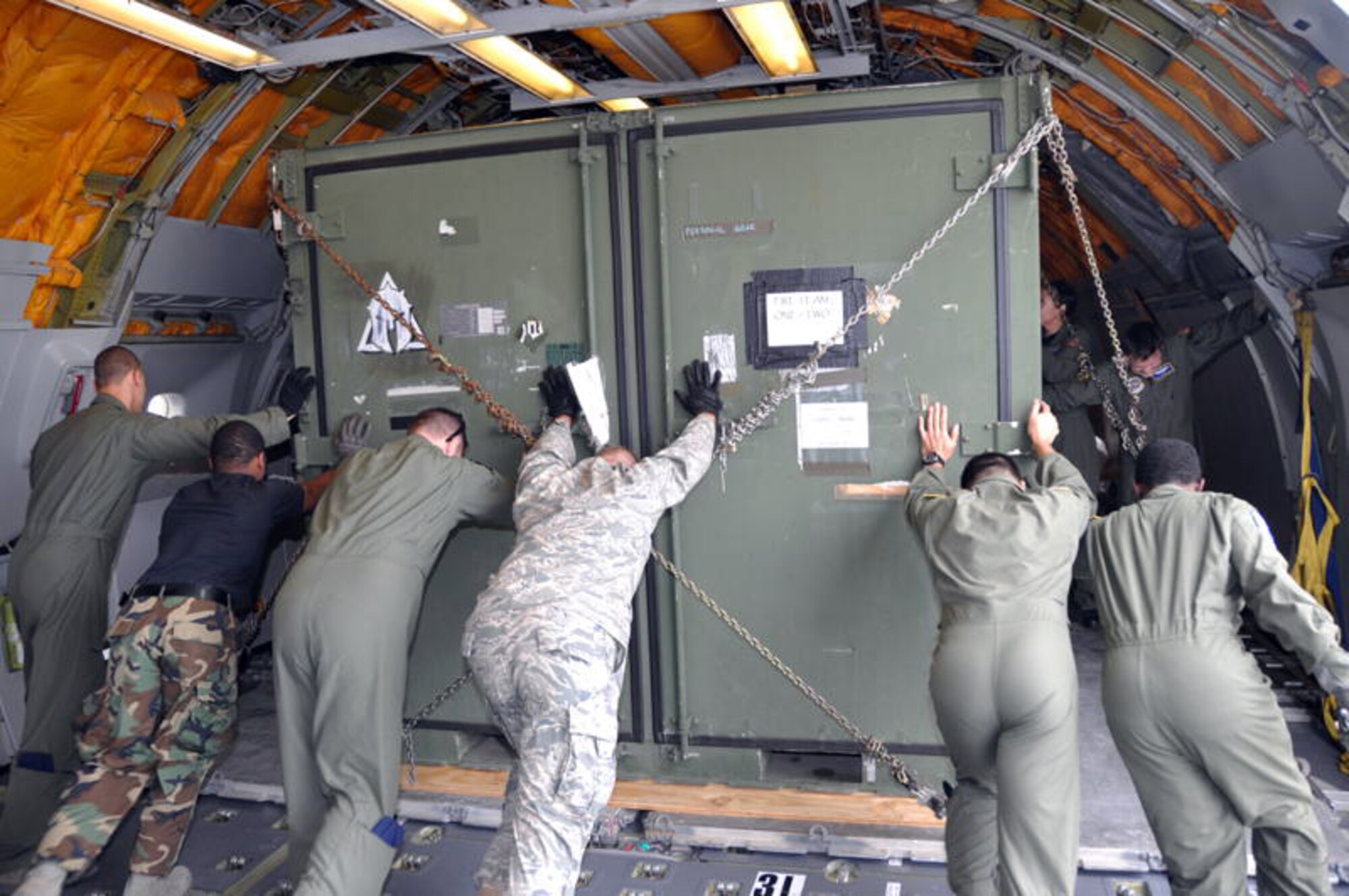 Airmen from Travis push a cargo box on a pallet to the rear of the cargo compartment in a KC-10 Extender Aug. 13. (U.S. Air Force photo/Staff Sgt.  Patrick Harrower)