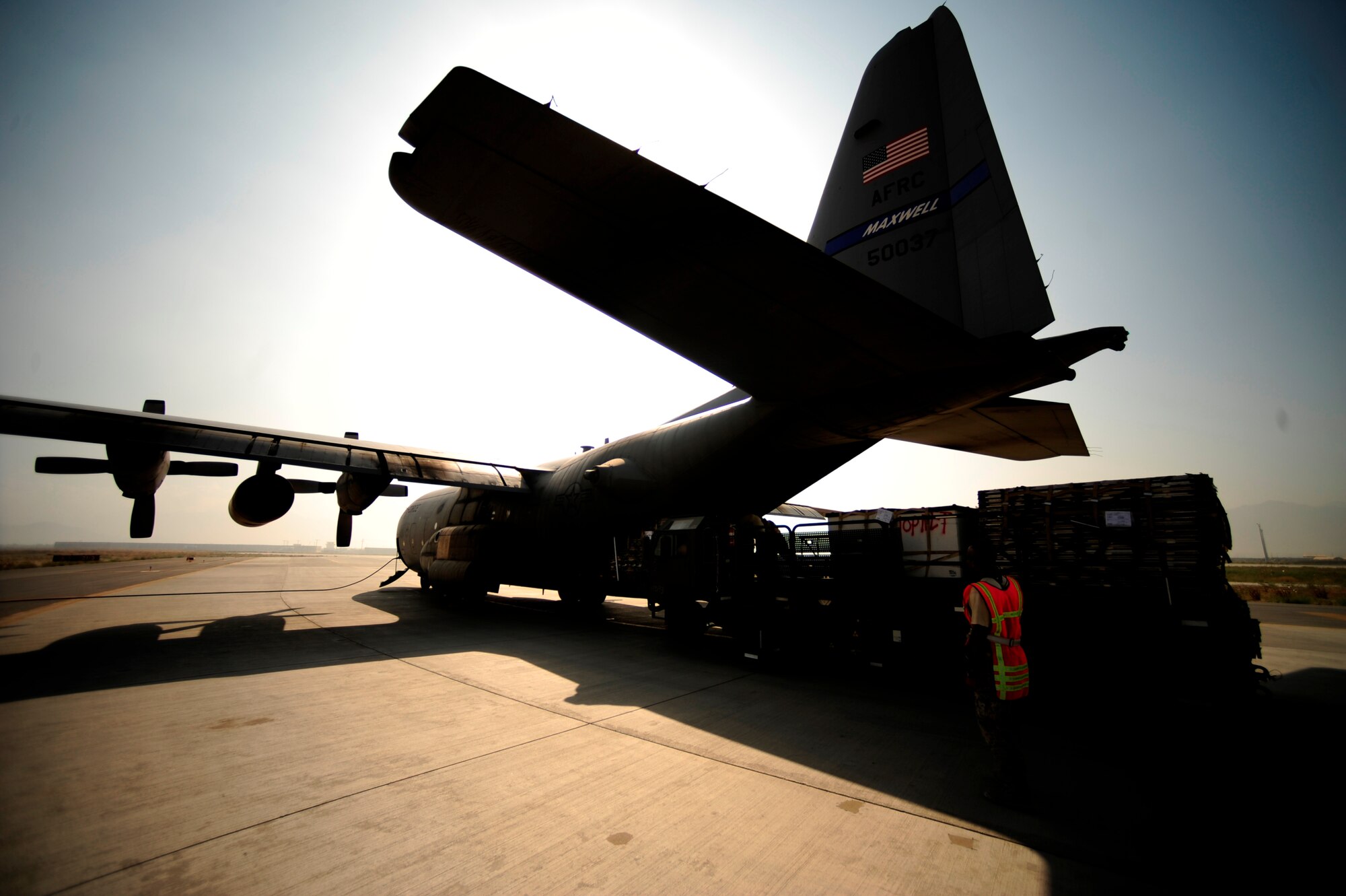 U.S. Air Force Airmen aircraft from the 746th Expeditionary Airlift Squadron load aid and supplies onto a C-130H Hercules, in support of humanitarian relief efforts in Pakistan at Bagram Airfield, Afghanistan, Aug. 20, 2010. (U.S. Air Force photo by Staff Sgt. Andy M. Kin/Released)