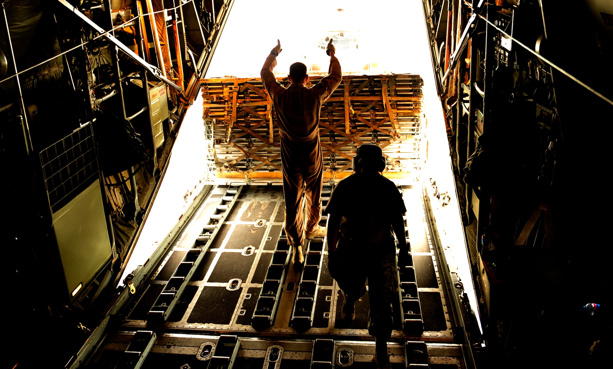 U.S. Air Force Master Sgt. John Metcalf, a C-130H Hercules loadmaster assigned to the 746th Expeditionary Airlift Squadron, backs cargo off the aircraft in support humanitarian relief efforts in Pakistan Aug. 20, 2010. The 746 EAS is staged out of Bagram Airfield, Afghanistan, and run missions to Pakistan daily. (U.S. Air Force photo by Staff Sgt. Andy M. Kin/Released)