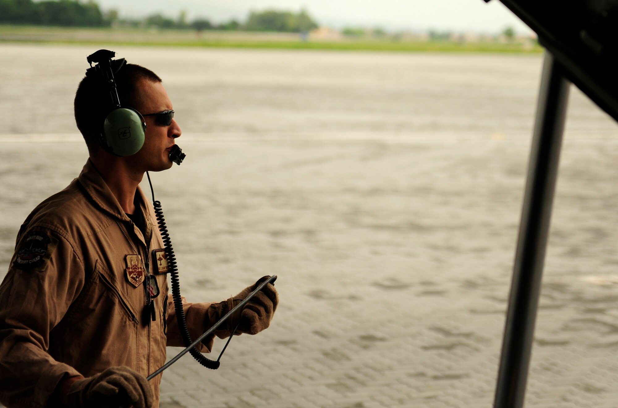 U.S. Air Force Master Sgt. John Metcalf a C-130H Hercules, loadmaster assigned to the 746th Expeditionary Airlift Squadron, waits on ground crew for cargo off load in Pakistan during humanitarian relief mission out of Bagram Airfield, Afghanistan, Aug. 20, 2010. (U.S. Air Force photo by Staff Sgt. Andy M. Kin/Released)