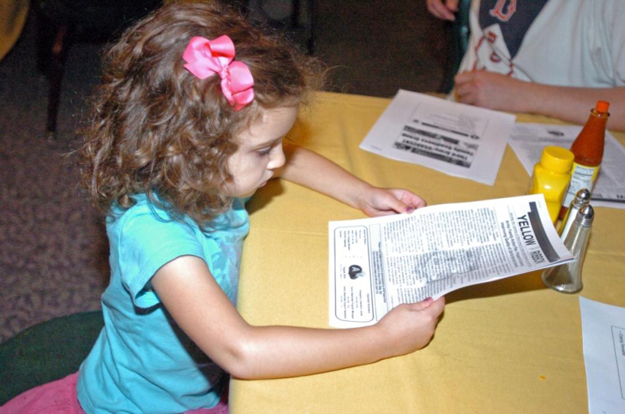 SUMTER, S.C. (Aug. 19, 2010) Eleanor Yokel, daughter of Army Staff Sgt. Peter Yokel, Third Army/U.S. Army Central Advanced Party Communications noncommissioned officer in charge, looks over a copy of the Yellow Ribbon at Third Army?s first Family Readiness Group meeting at Shaw Air Force Base, S.C., Aug. 19. Members of the City of Sumter as well as the Airmen Family Readiness Center spoke during the meeting, highlighting activities and services available to Third Army Families as they join the Sumter community. (Photo by Sgt. Beth Lake, Third Army/USARCENT Public Affairs) 