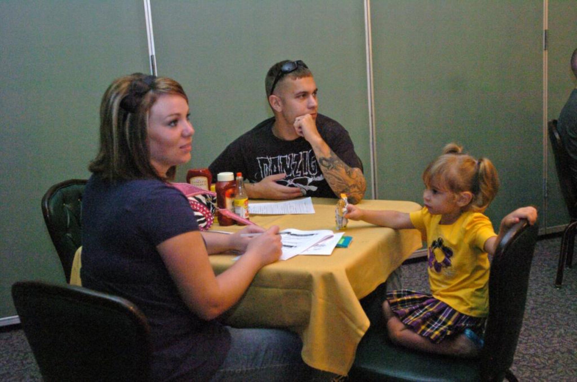 SUMTER, S.C. (Aug. 19, 2010) ? Army Staff Sgt. Thomas Brown, Third Army/U.S. Army Central Advanced Party Operations noncommissioned officer in charge, attends Third Army?s first Family Readiness Group meeting at Shaw Air Force Base with his wife Janetta and daughter Chloe, Aug. 19. FRG meetings will be held monthly at Shaw AFB as the command transitions to Sumter over the next year. (Photo by Sgt. Beth Lake, Third Army/USARCENT Public Affairs)  