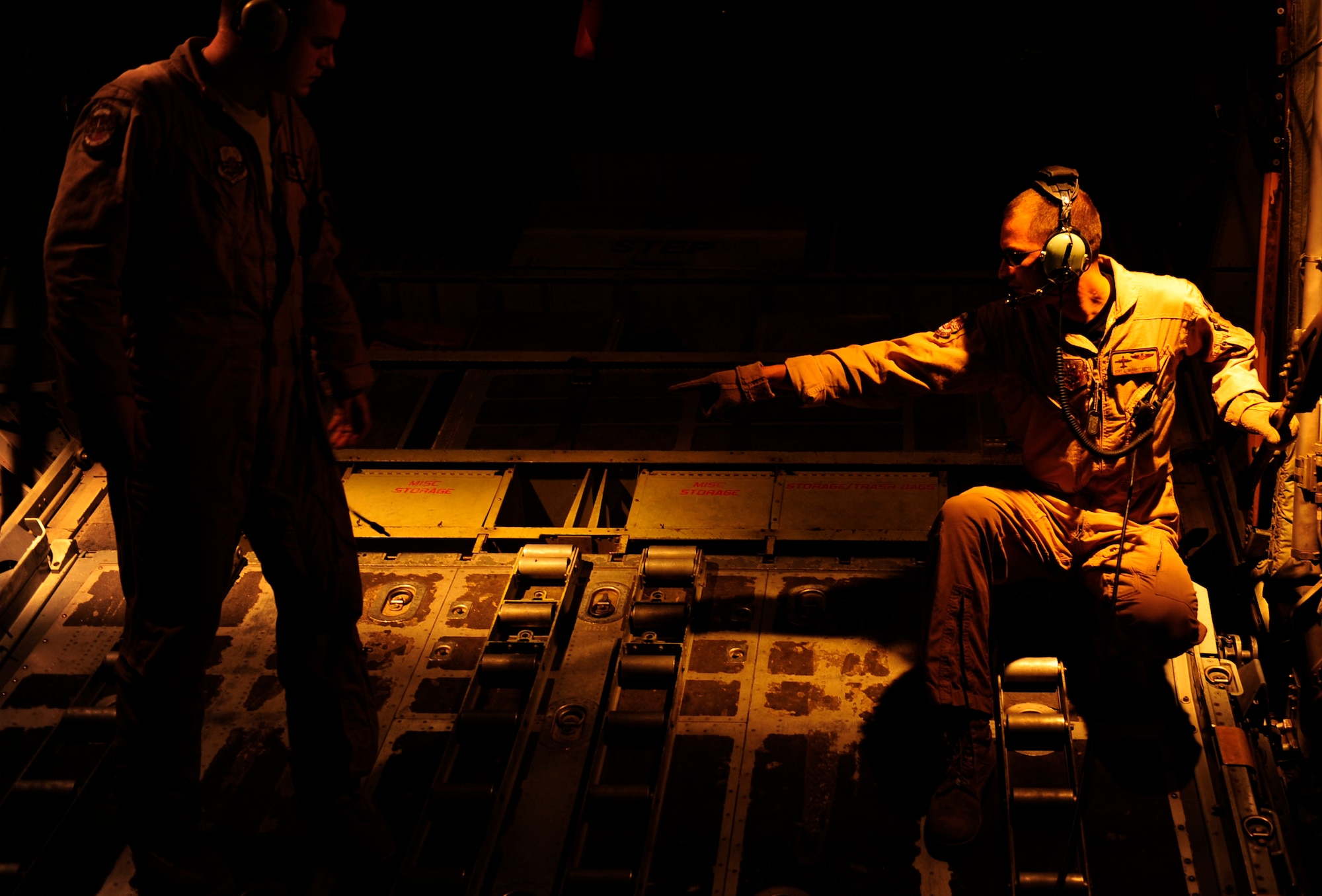 U.S. Air Force Master Sgt. John Metcalf, a C-130H Hercules loadmaster assigned to the 746th Expeditionary Airlift Squadron, directs his crew to release cargo straps prior to cargo off load in Pakistan Aug. 20, 2010. The 746 EAS is staged out of Bagram Airfield, Afghanistan, in support of humanitarian relief efforts to Pakistan. (U.S. Air Force photo by Staff Sgt. Andy M. Kin/Released)